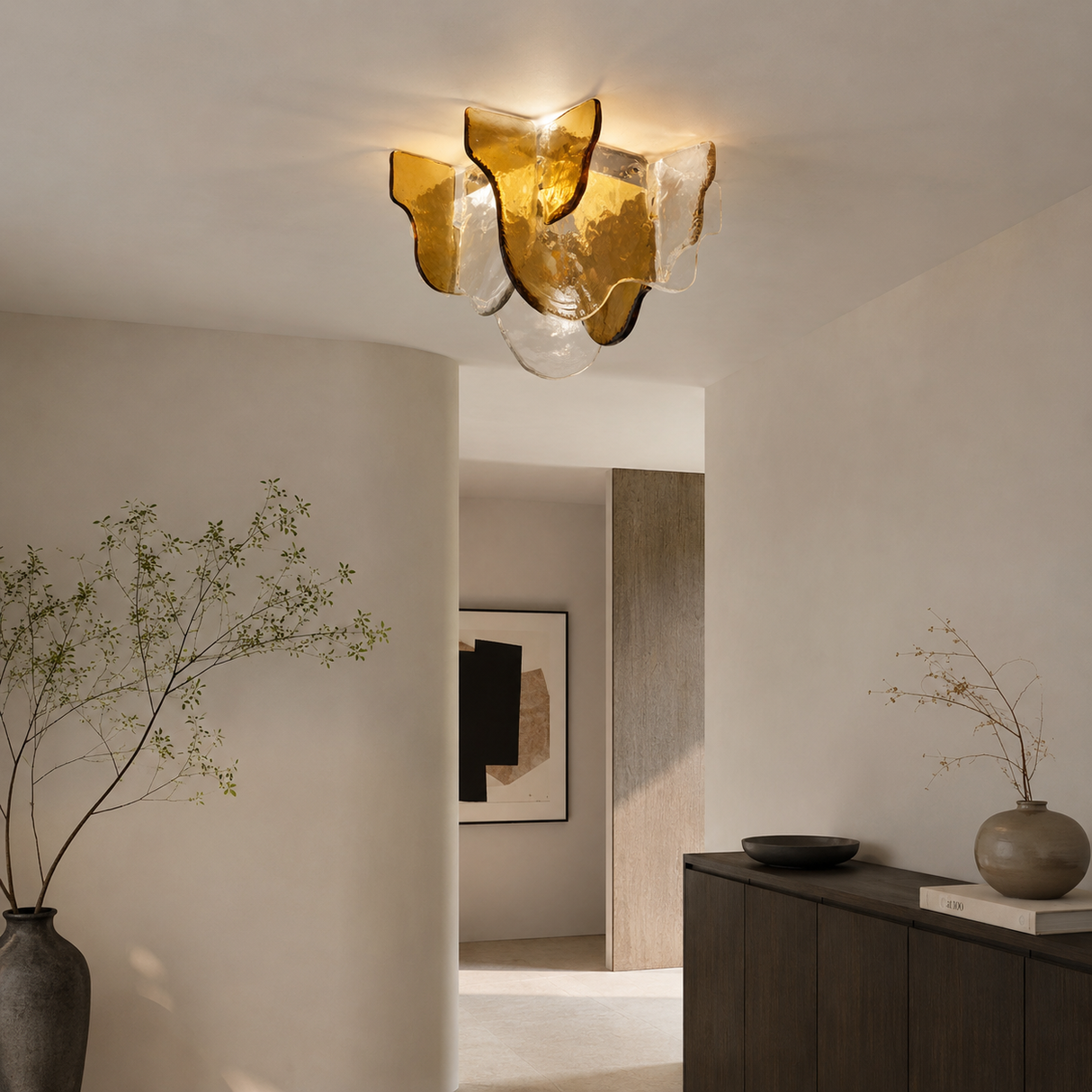Modern ceiling light fixture in a stylish interior setting with decor elements.