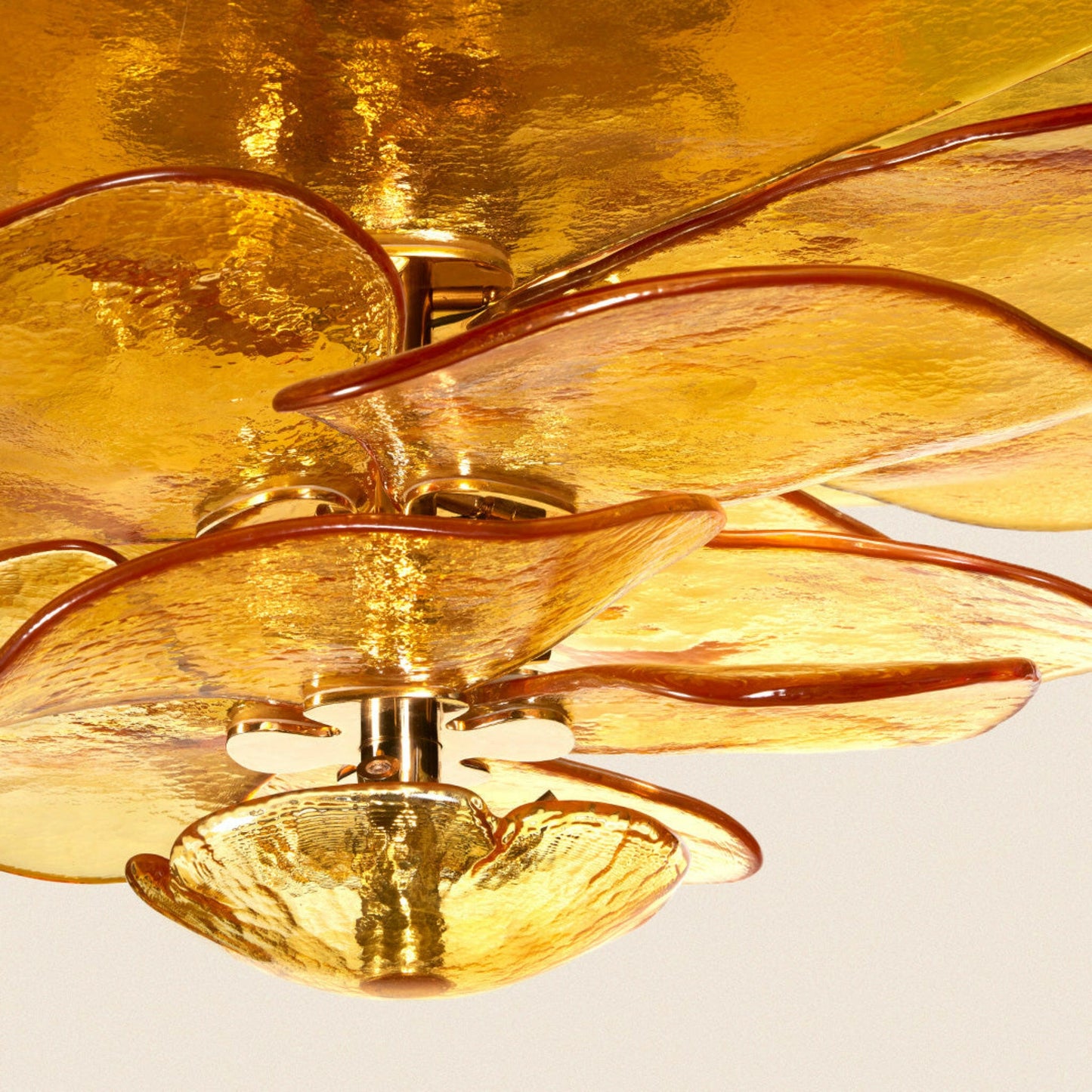 Gold ceiling fan with a reflective gold background