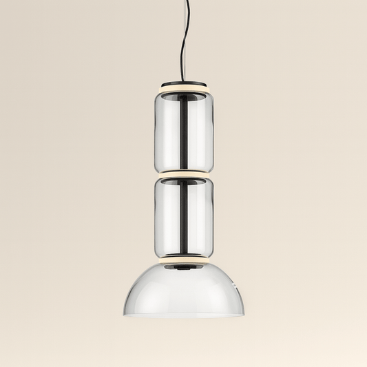 Modern pendant light with three cylindrical glass shades on a beige background