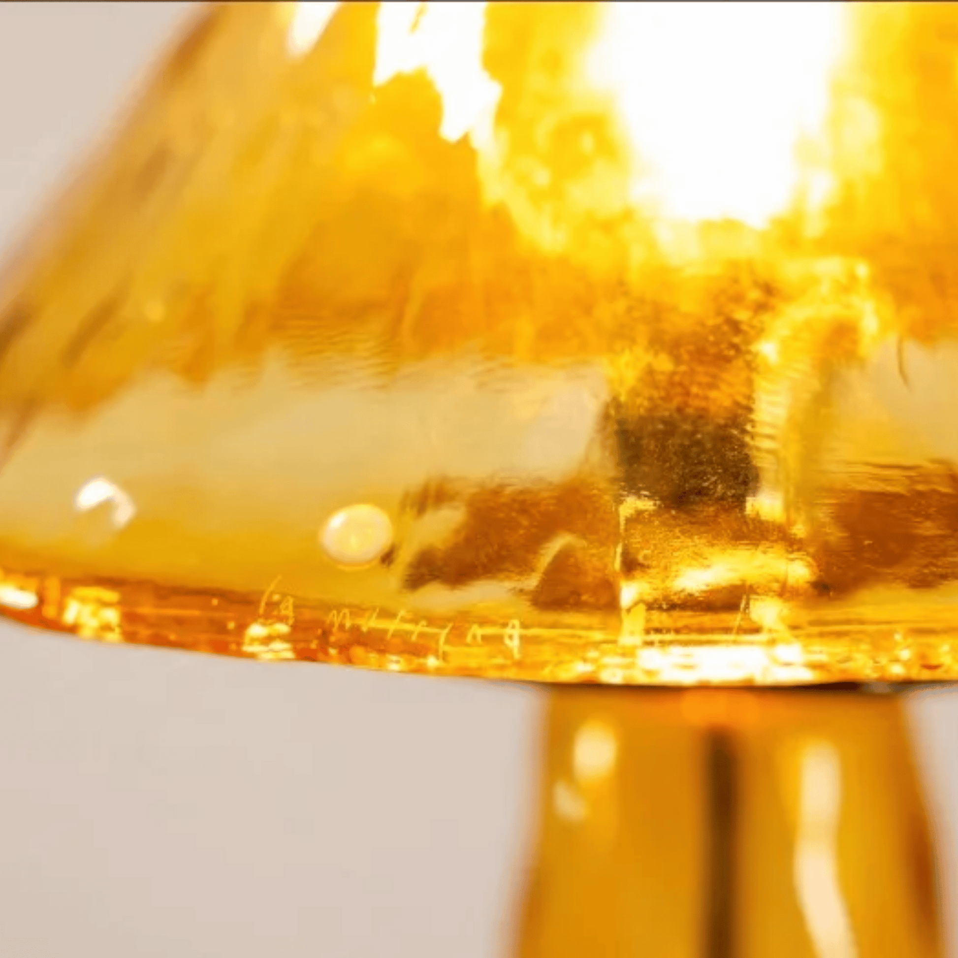 Close-up of a yellow glass object with a blurred background