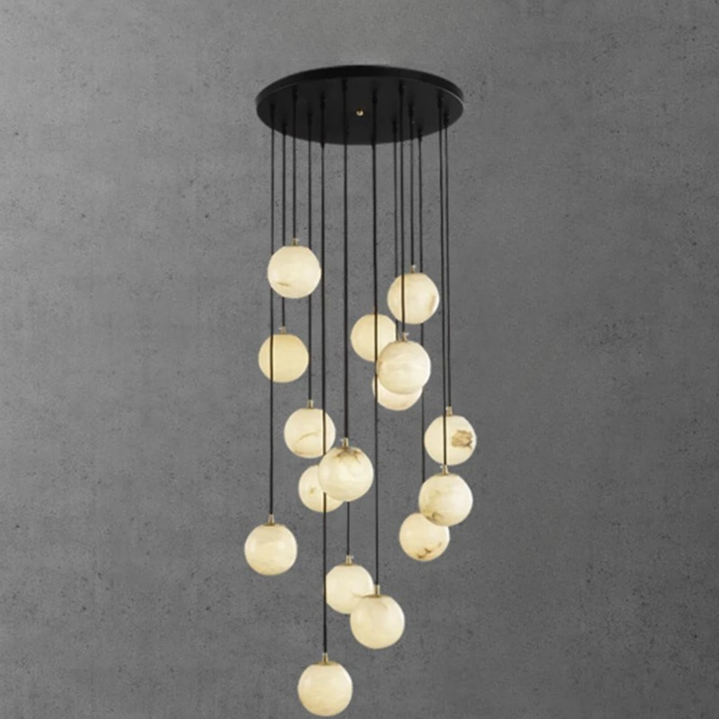 : A group of glowing spherical pendant lights arranged in a gentle curve, suspended from a dark ceiling mou