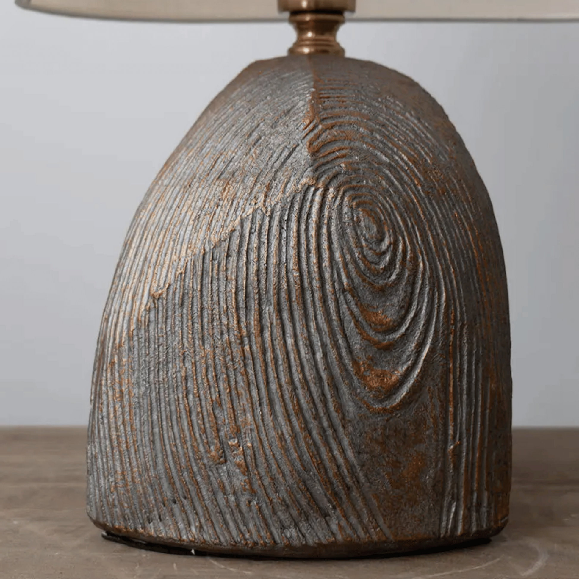 Textured ceramic lamp base on a neutral background