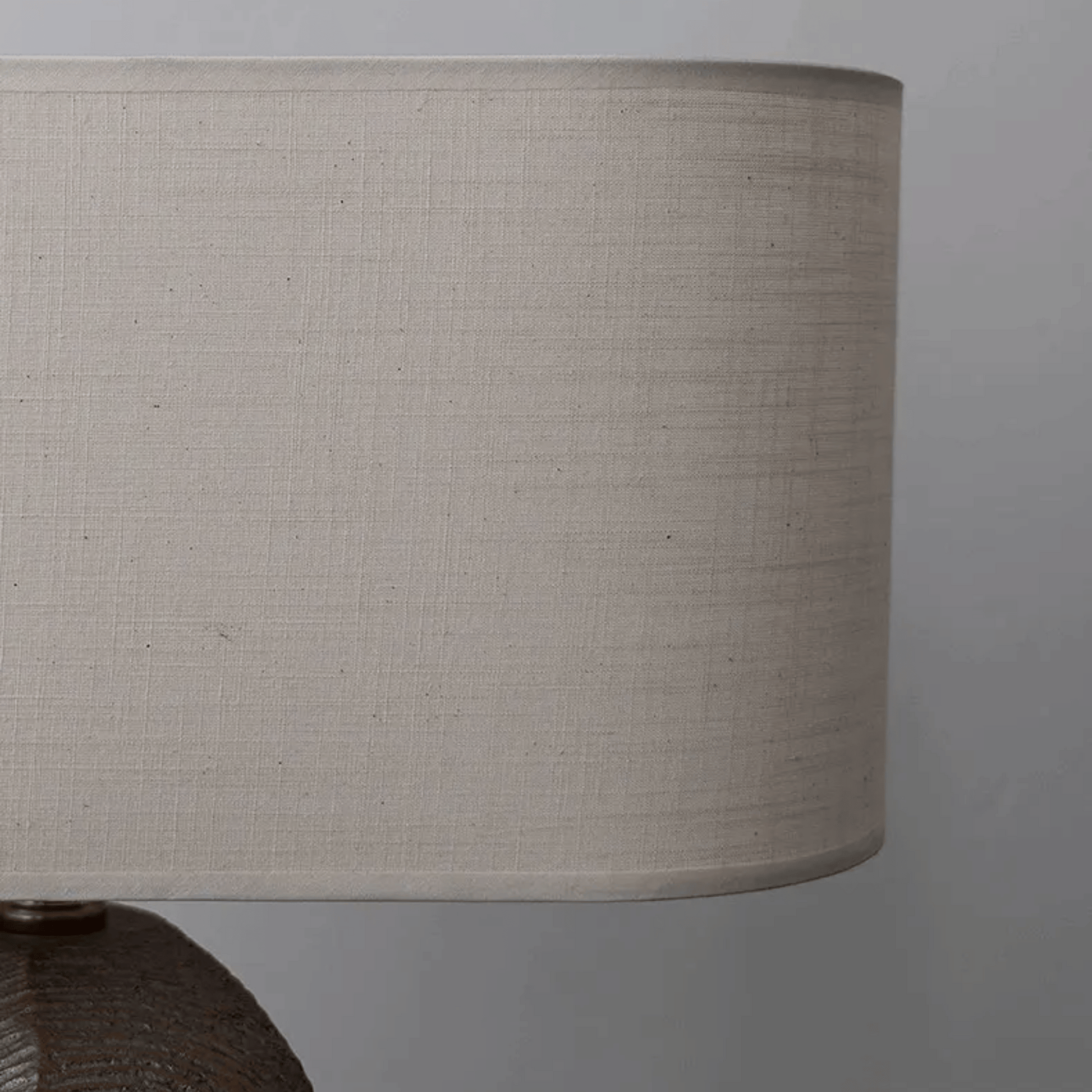 Close-up of a beige lampshade against a gray background