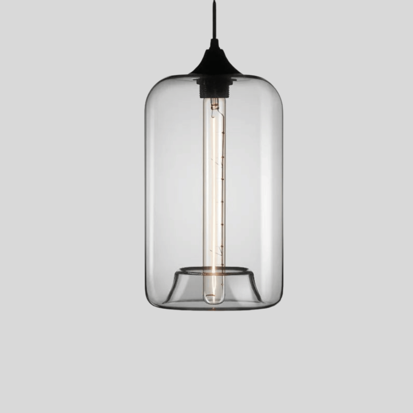 Clear glass pendant light with black fixture on a gray background