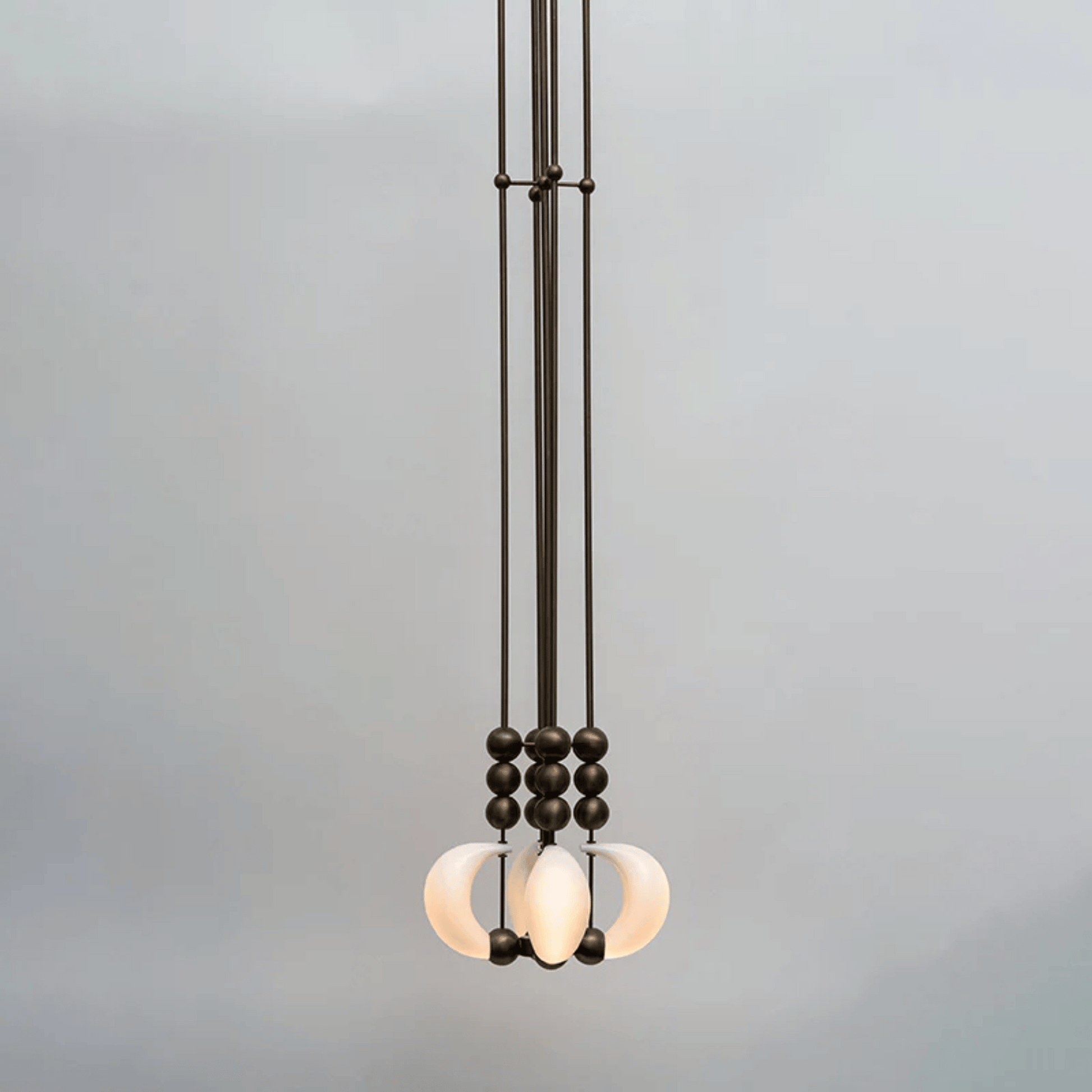 Modern pendant light with glass shades on a gray background