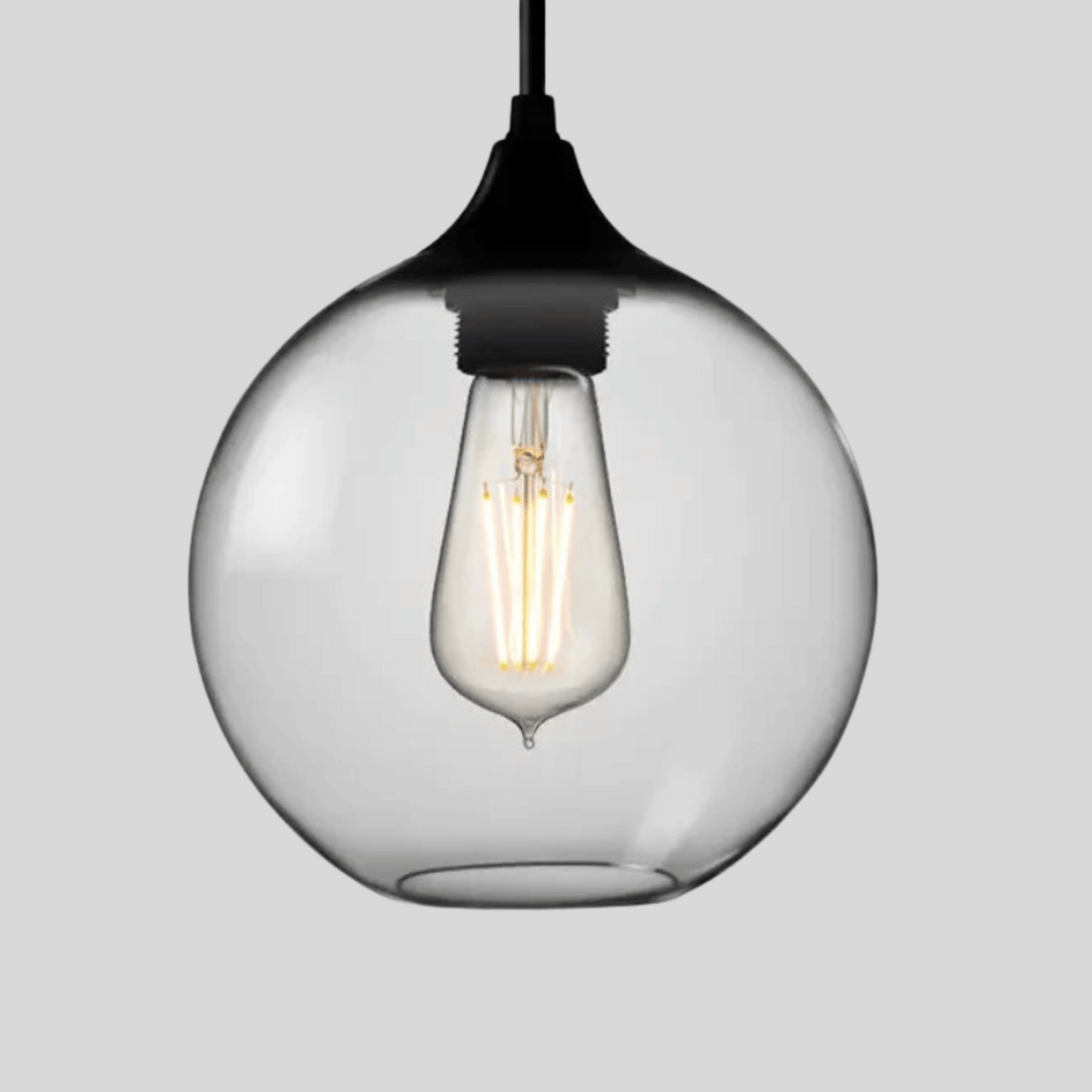 Clear glass pendant light with a black fixture on a gray background