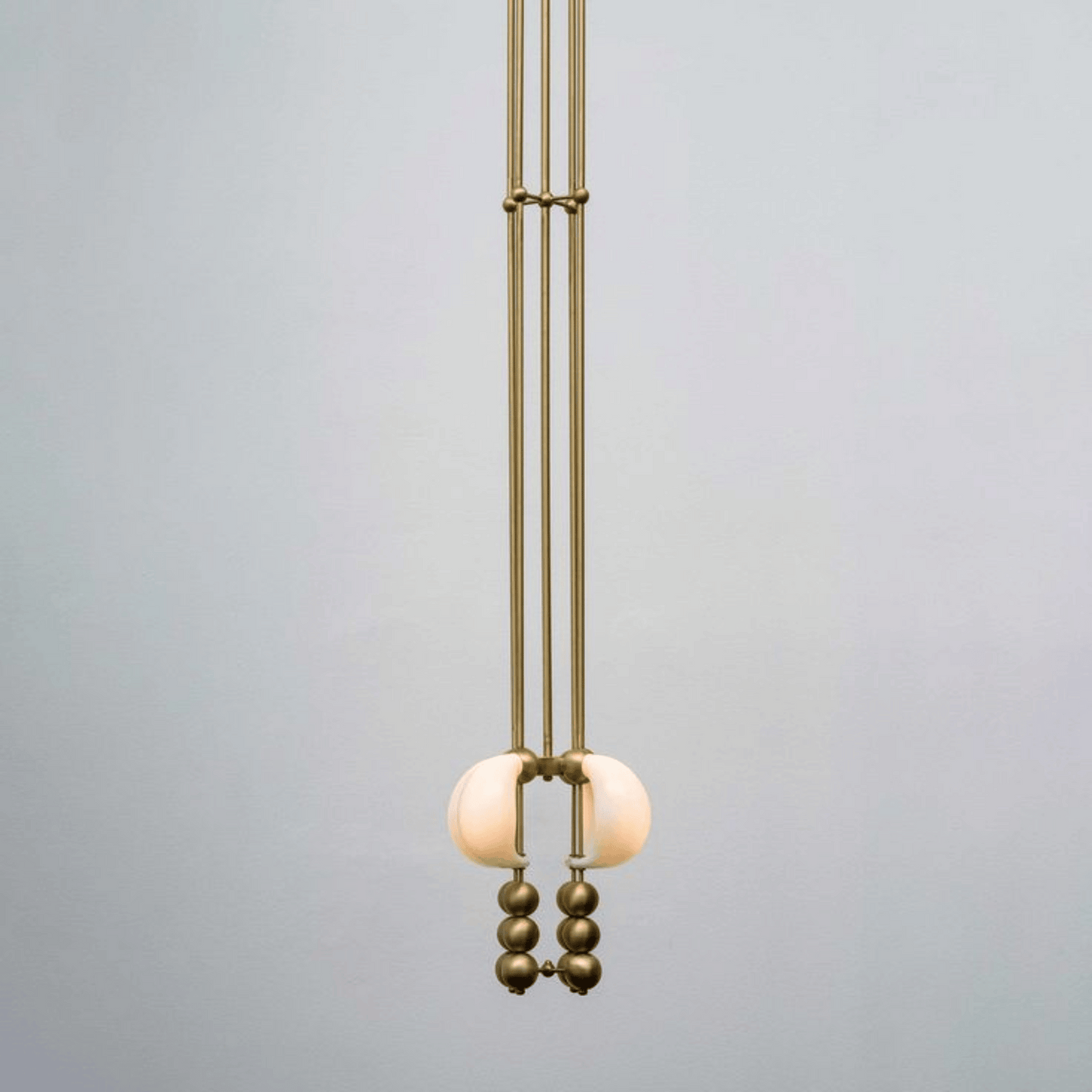 Modern pendant light with spherical design on a gray background