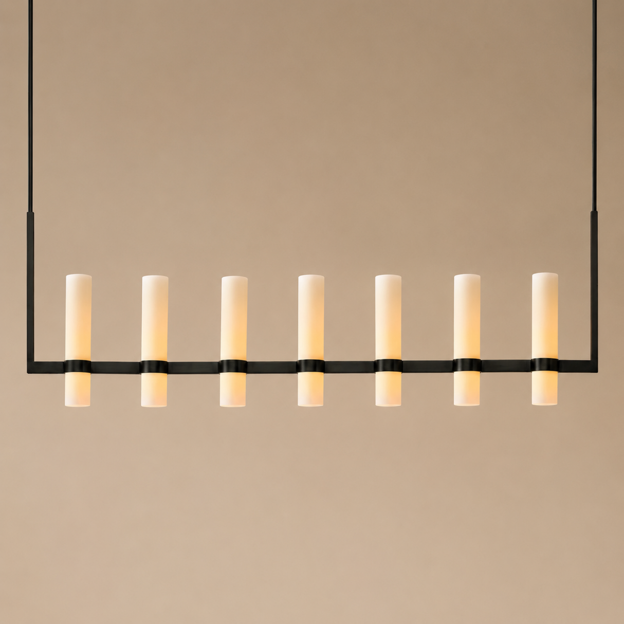 Modern pendant light with multiple cylindrical lights on a beige background