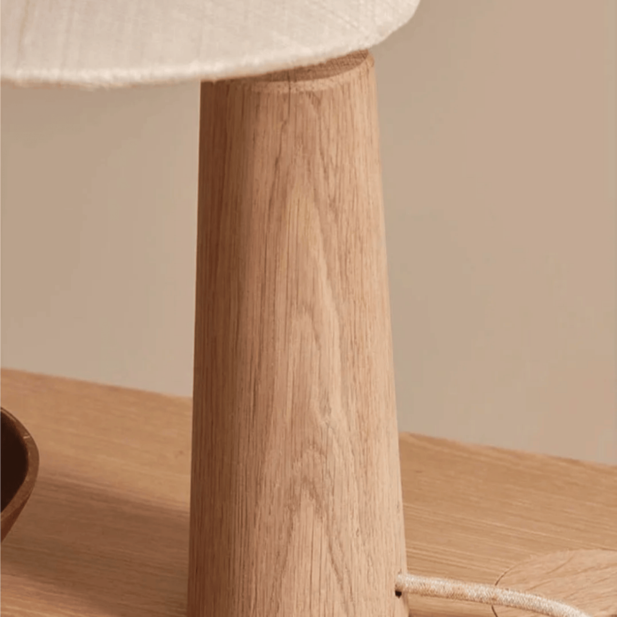 Close look at the stand of our Vintage Solid Wood LED Table Lamp with Fabric Shade for Living Room and Study on a coffee table.