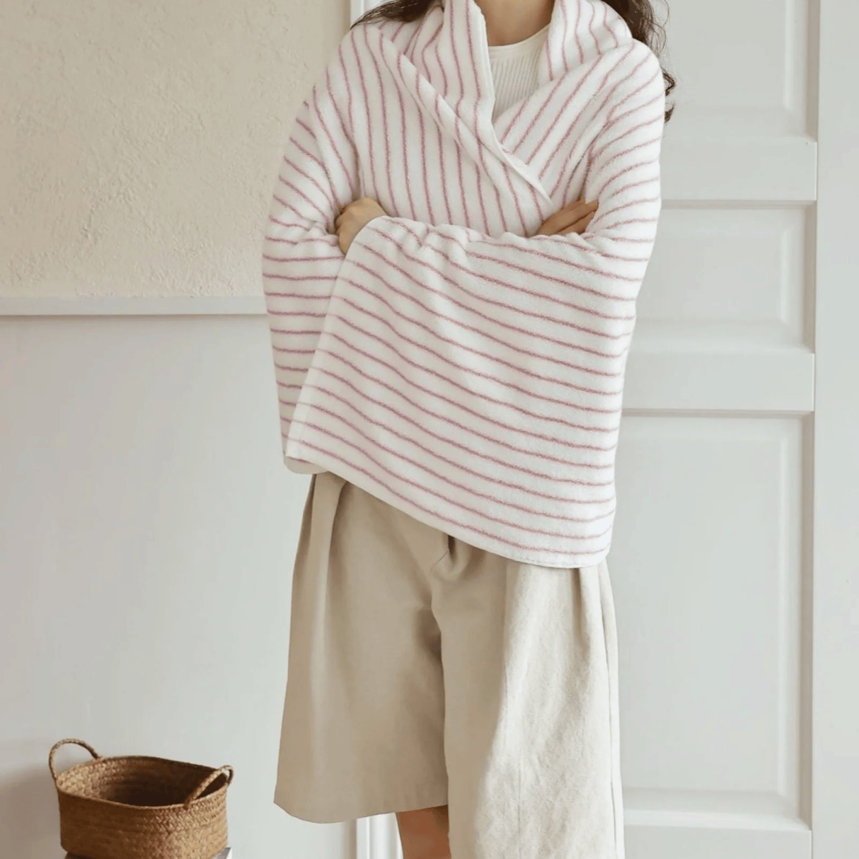 Someone wrapped in a pink and white bath towel