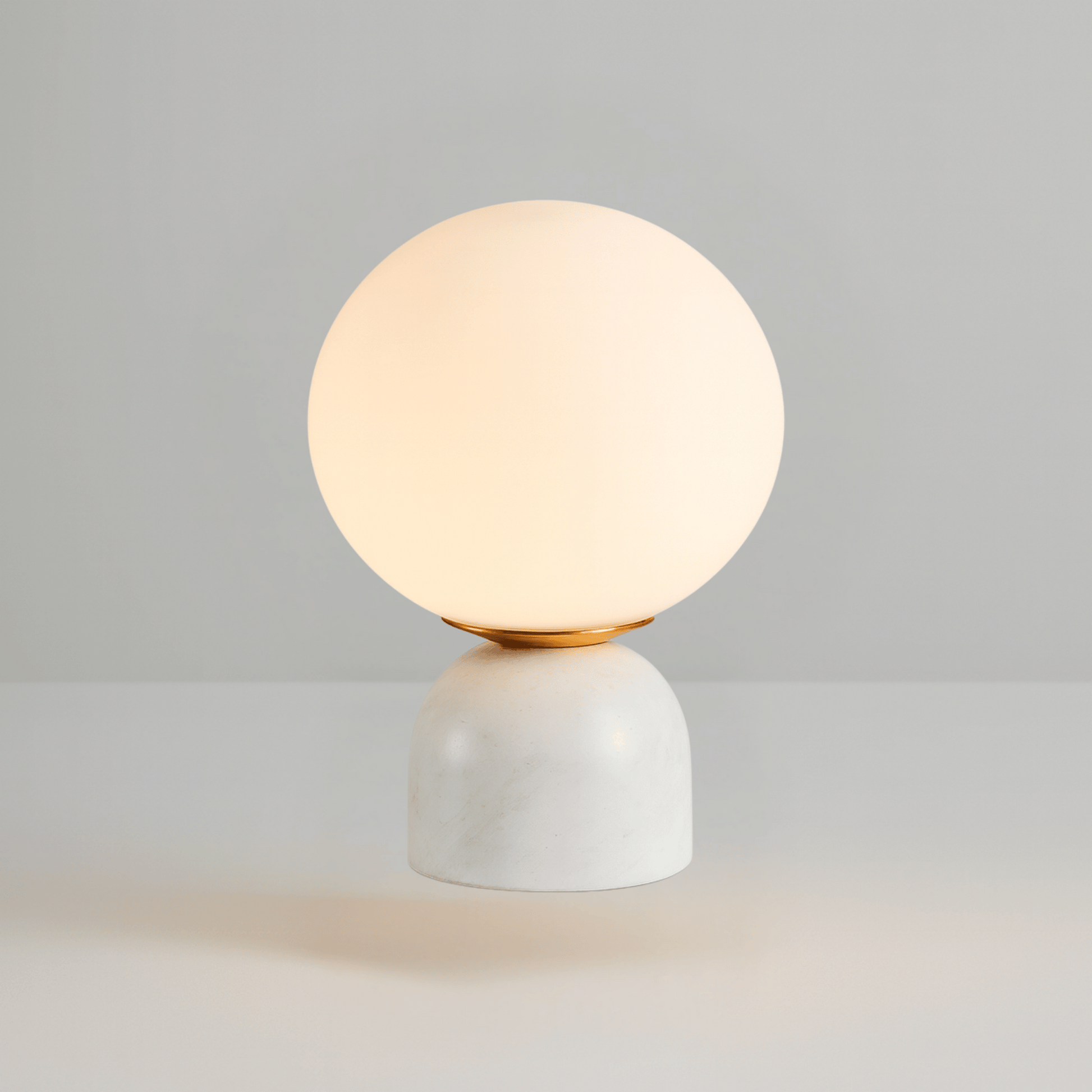 Spherical table lamp with a white base on a gray background