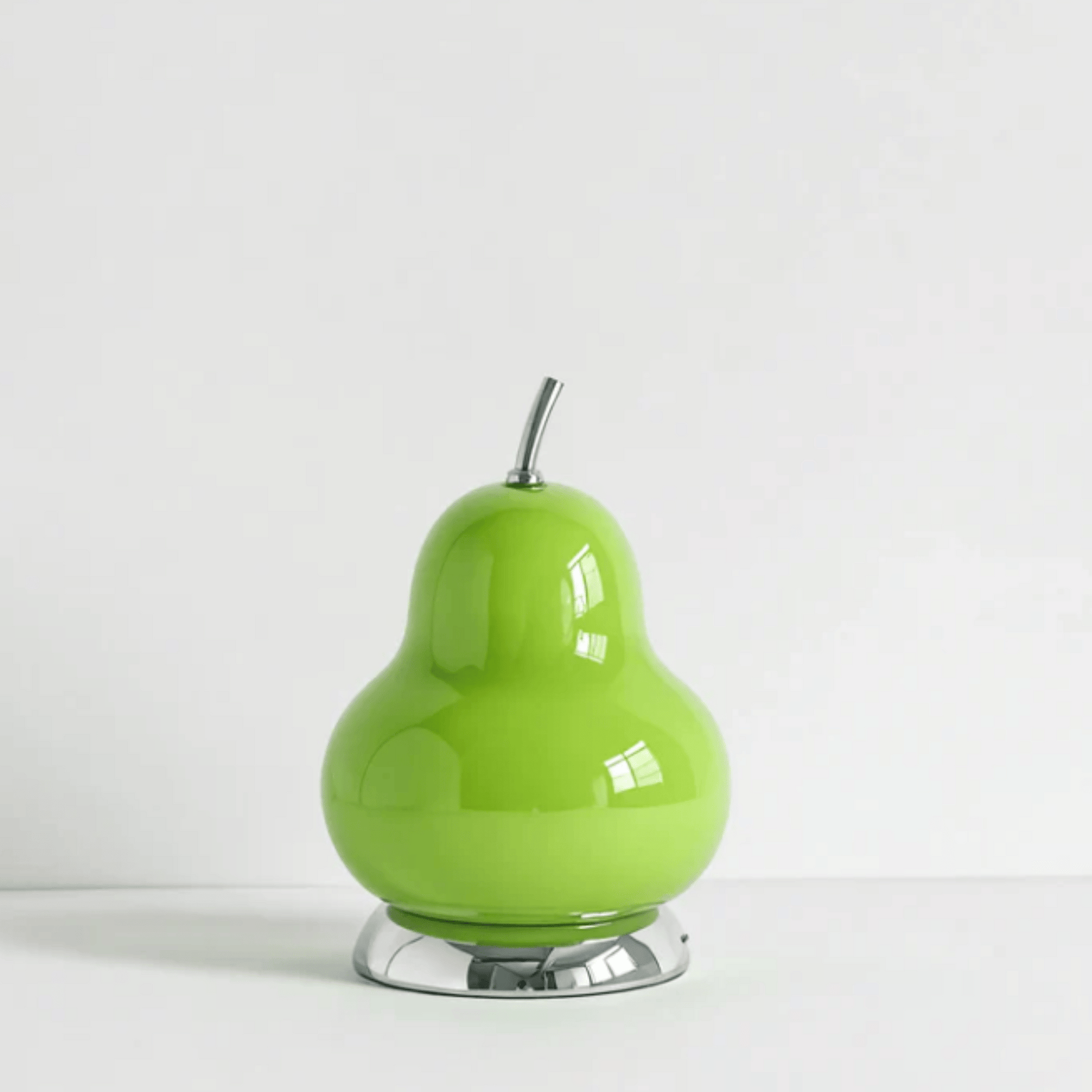 Green pear-shaped object with a silver base on a white background