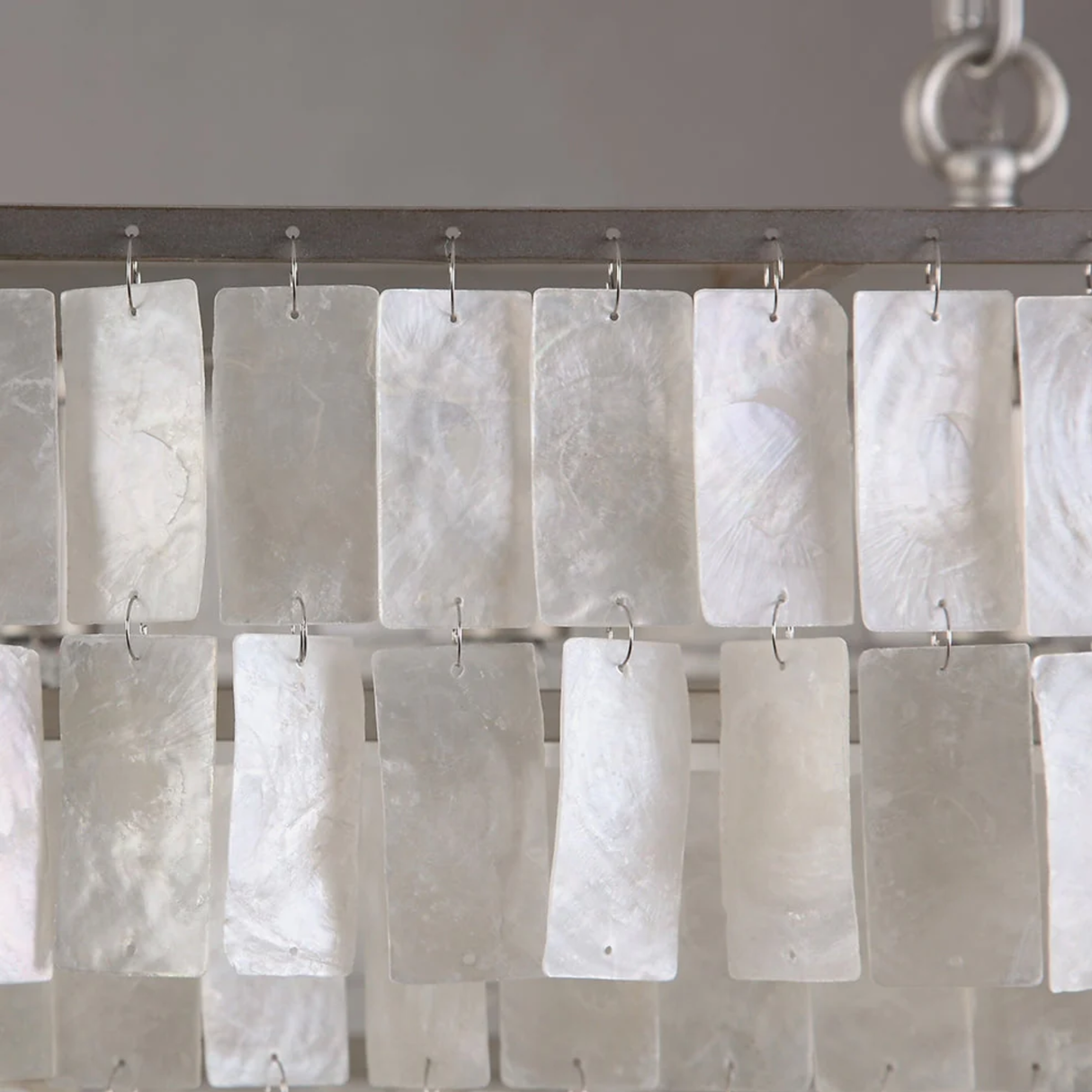 Shower curtain with white rectangular panels on a metal rod