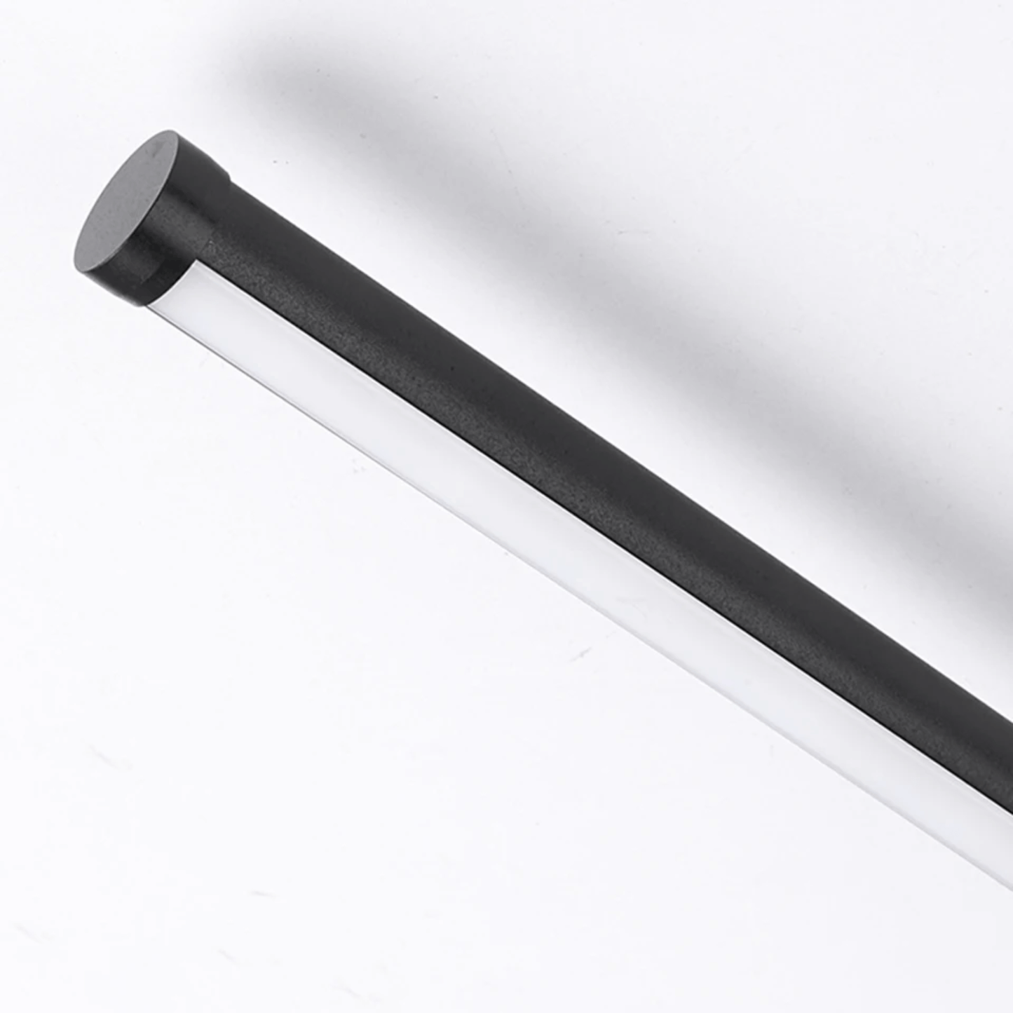 Black cylindrical object on a white background