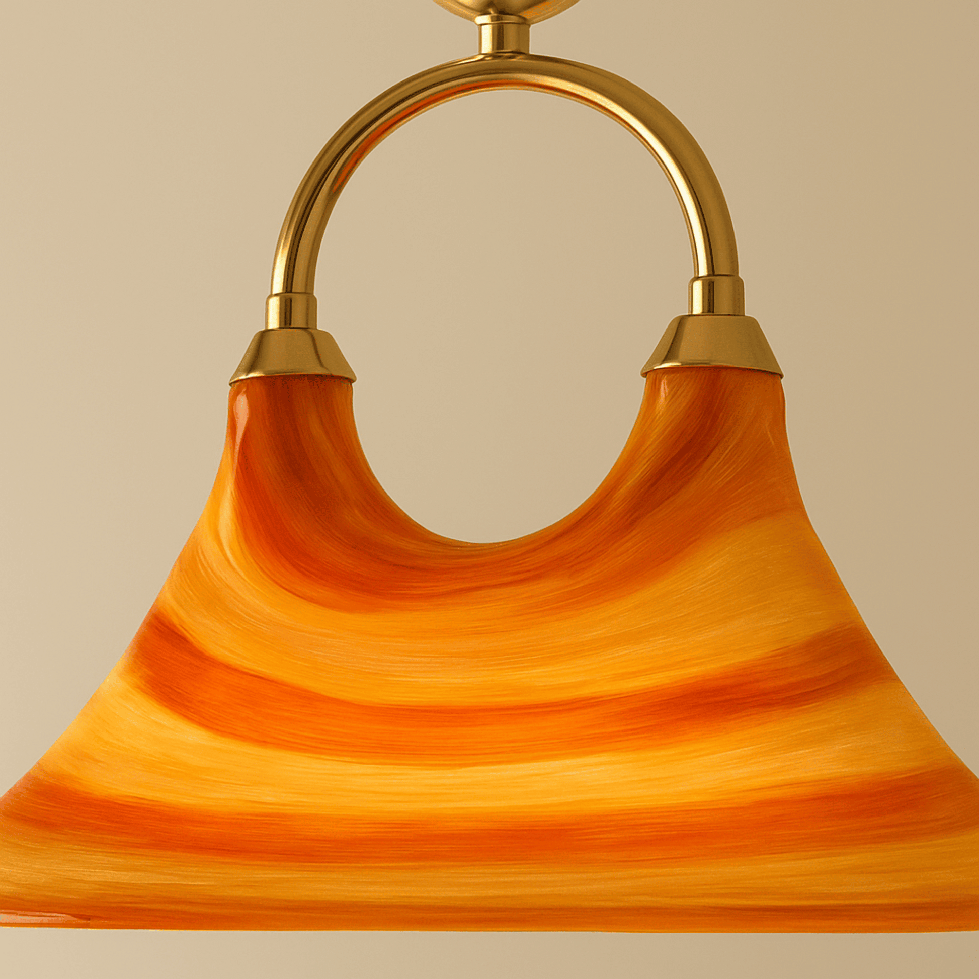 Close-up of a pendant light with orange glass shade and gold fixture on a beige background