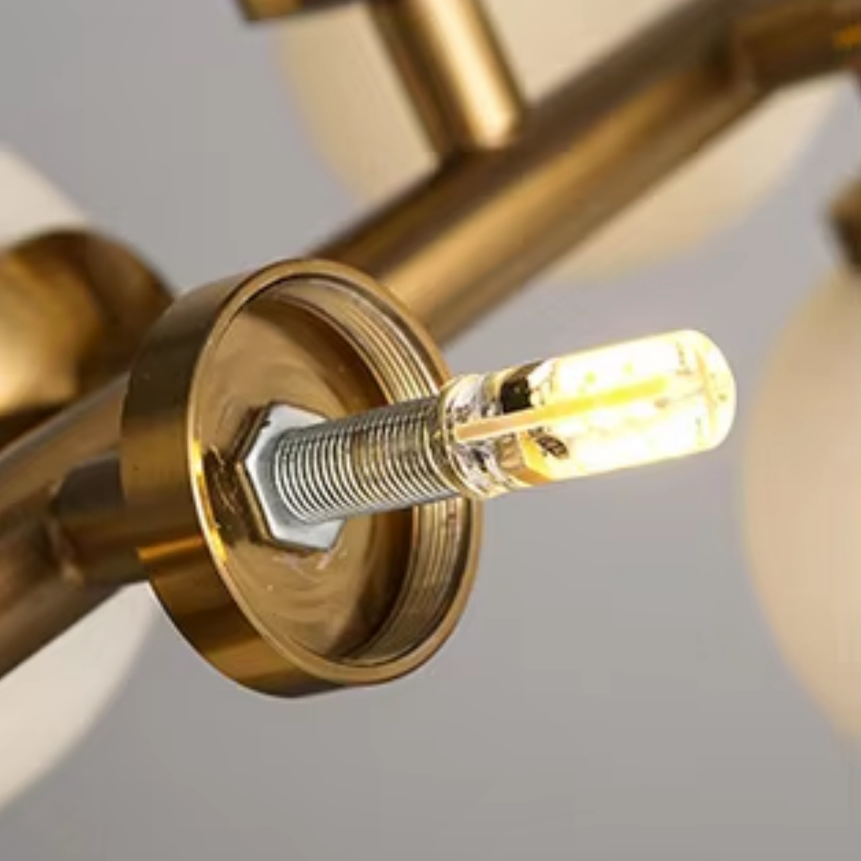 Close-up of a gold light fixture with a blurred background