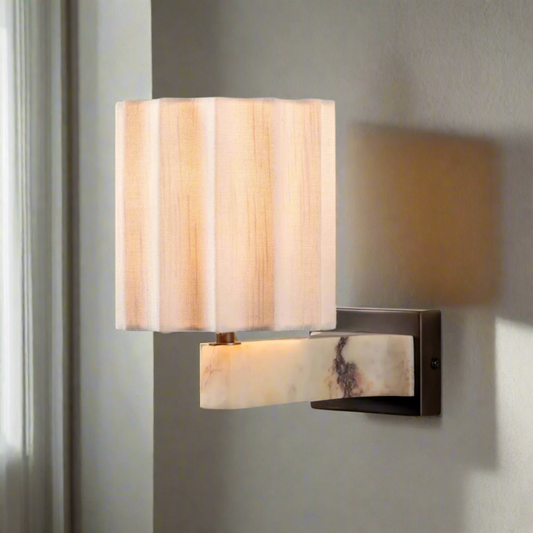 Wall sconce with marble-like finish on a white background