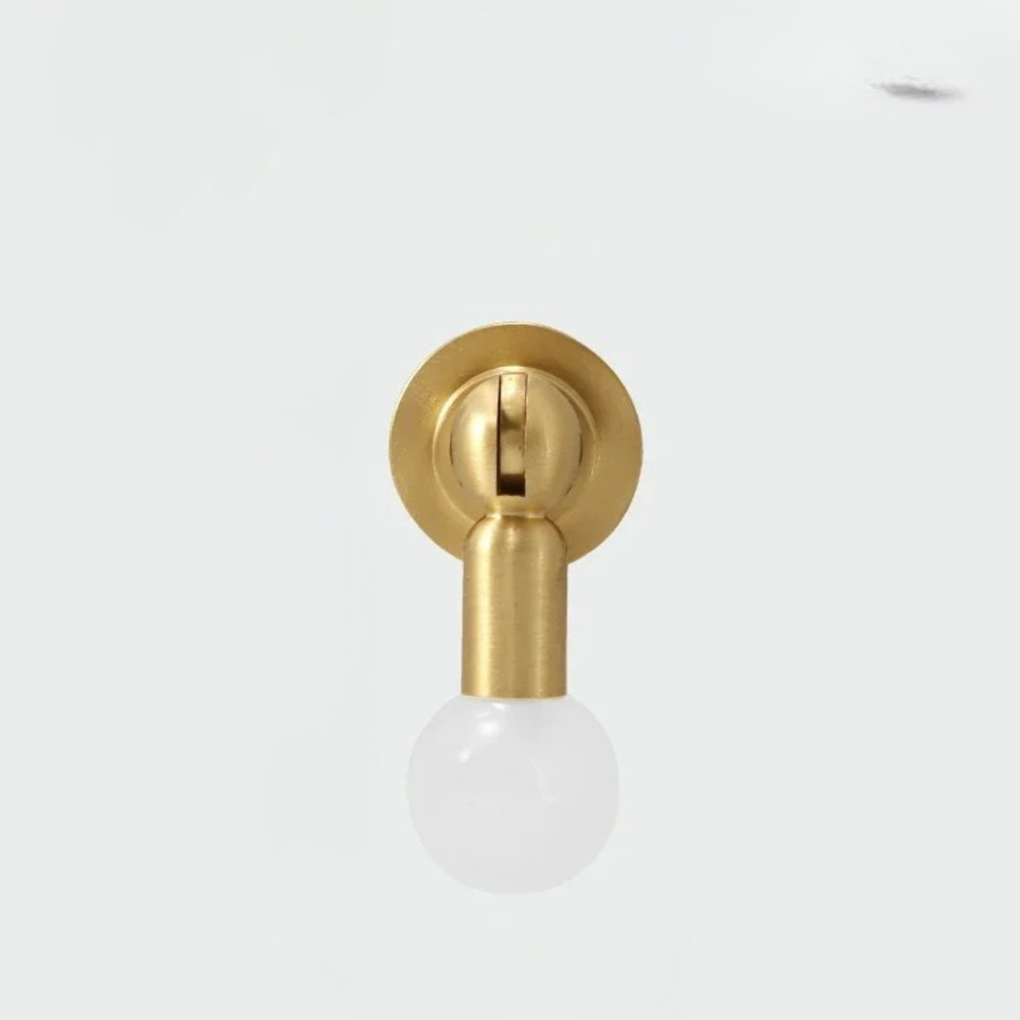 Minimal brass cabinet knob with a frosted white gemstone sphere handle on white background.