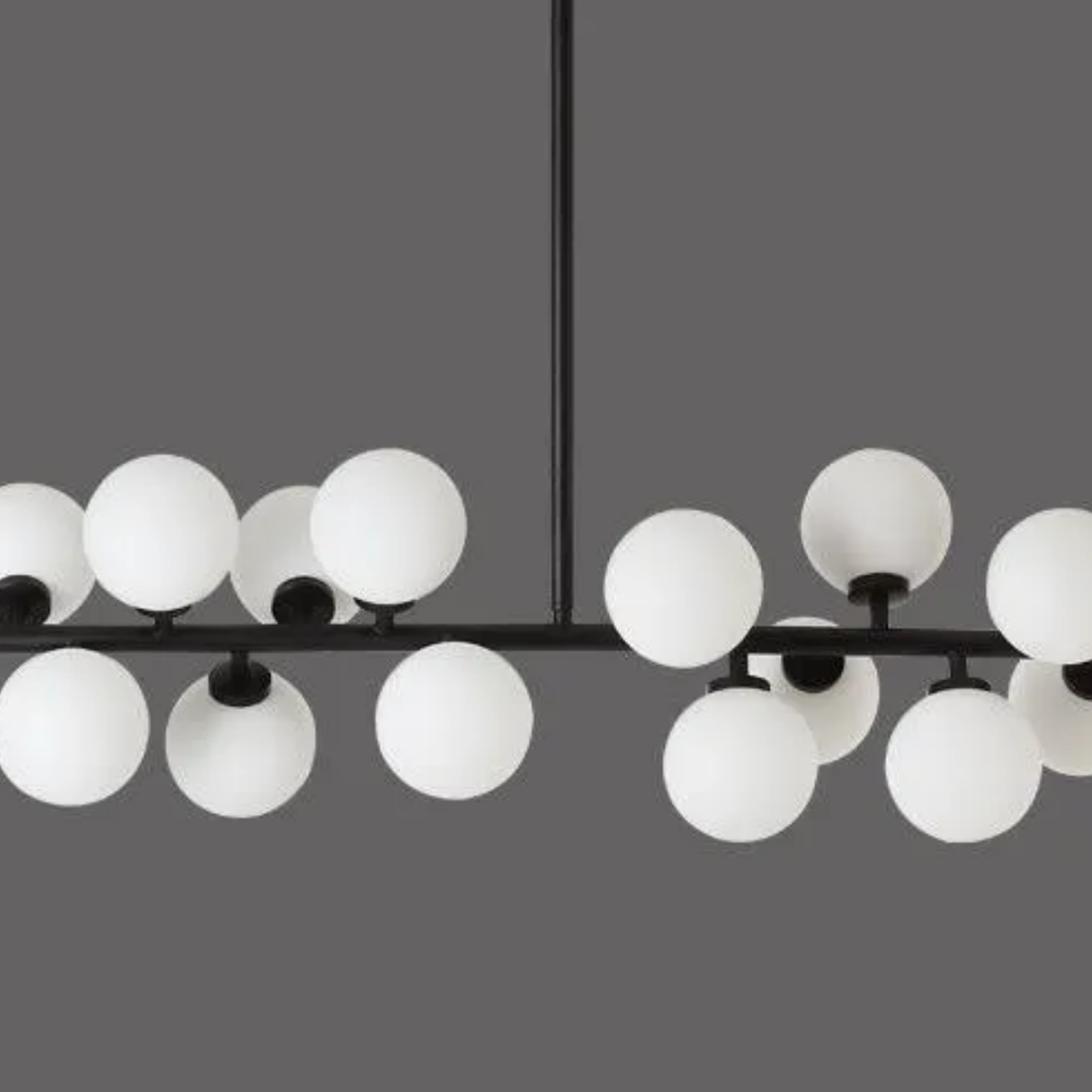 Modern chandelier with multiple round glass lights on a gray background