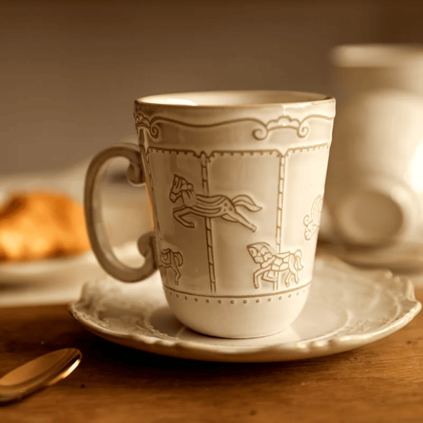 White ceramic cup with decorative horse design on a saucer, blurred background