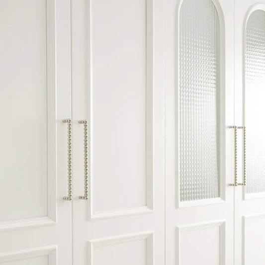 Close-up of a white cabinet with decorative elements