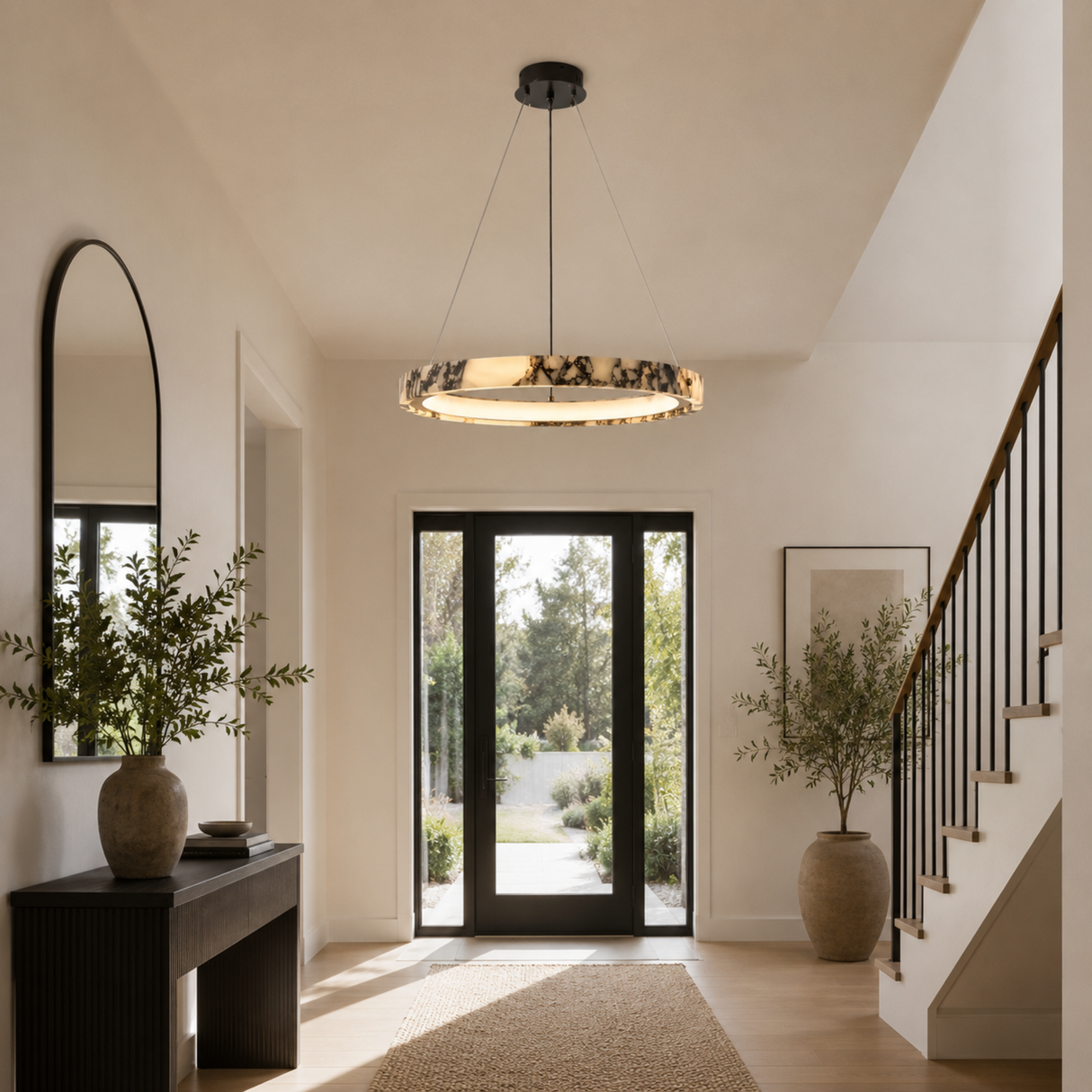 Modern interior with a chandelier, mirror, and plants in a well-lit room.
