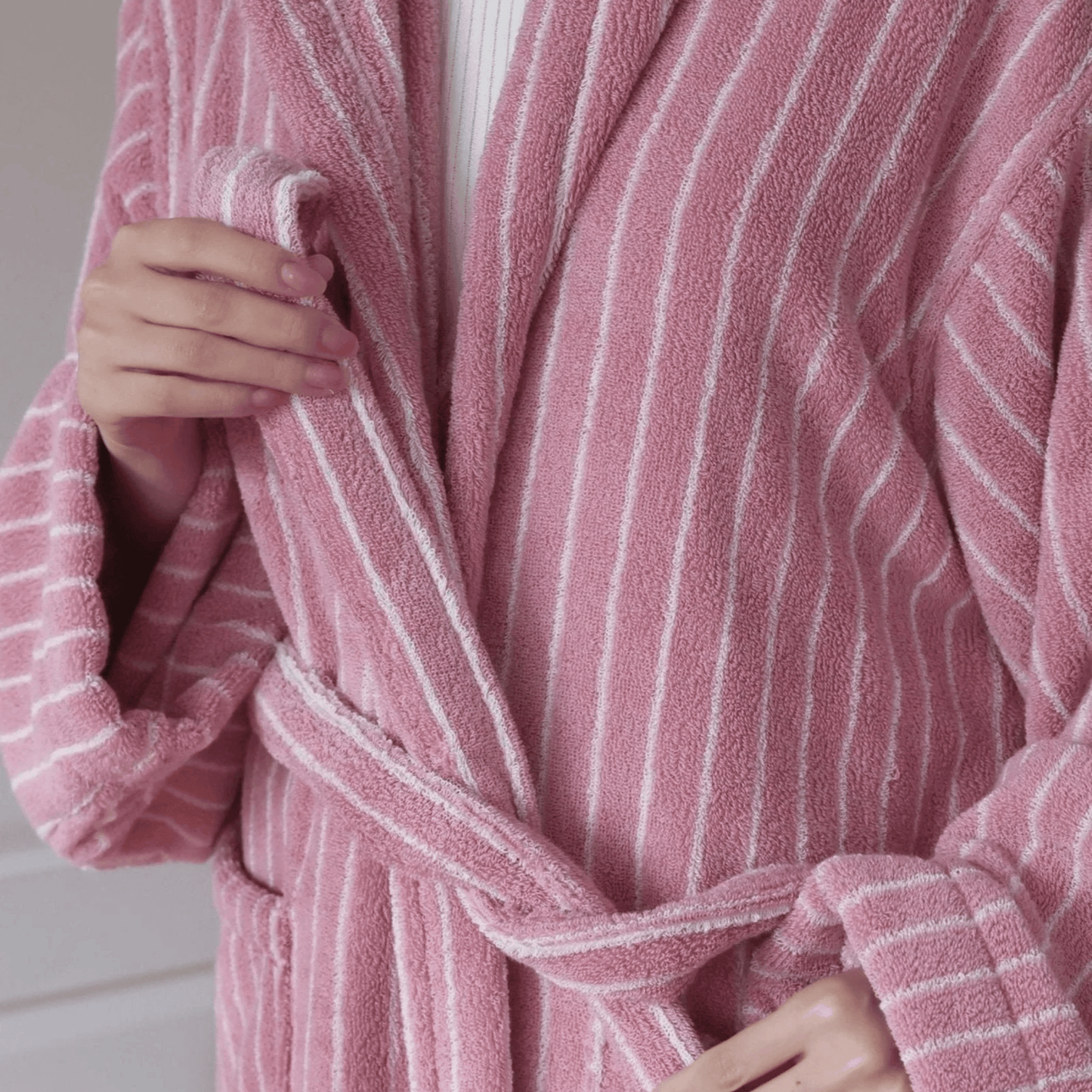 Close-up of a pink and white striped robe with a blurred background