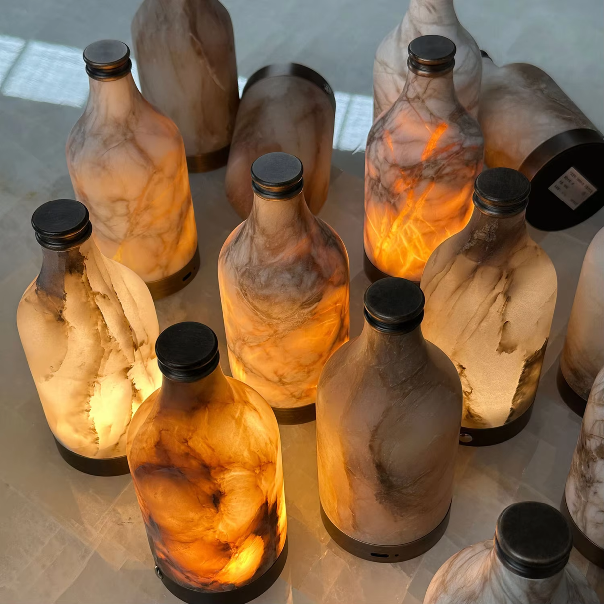 Decorative bottles with a warm glow on a reflective surface