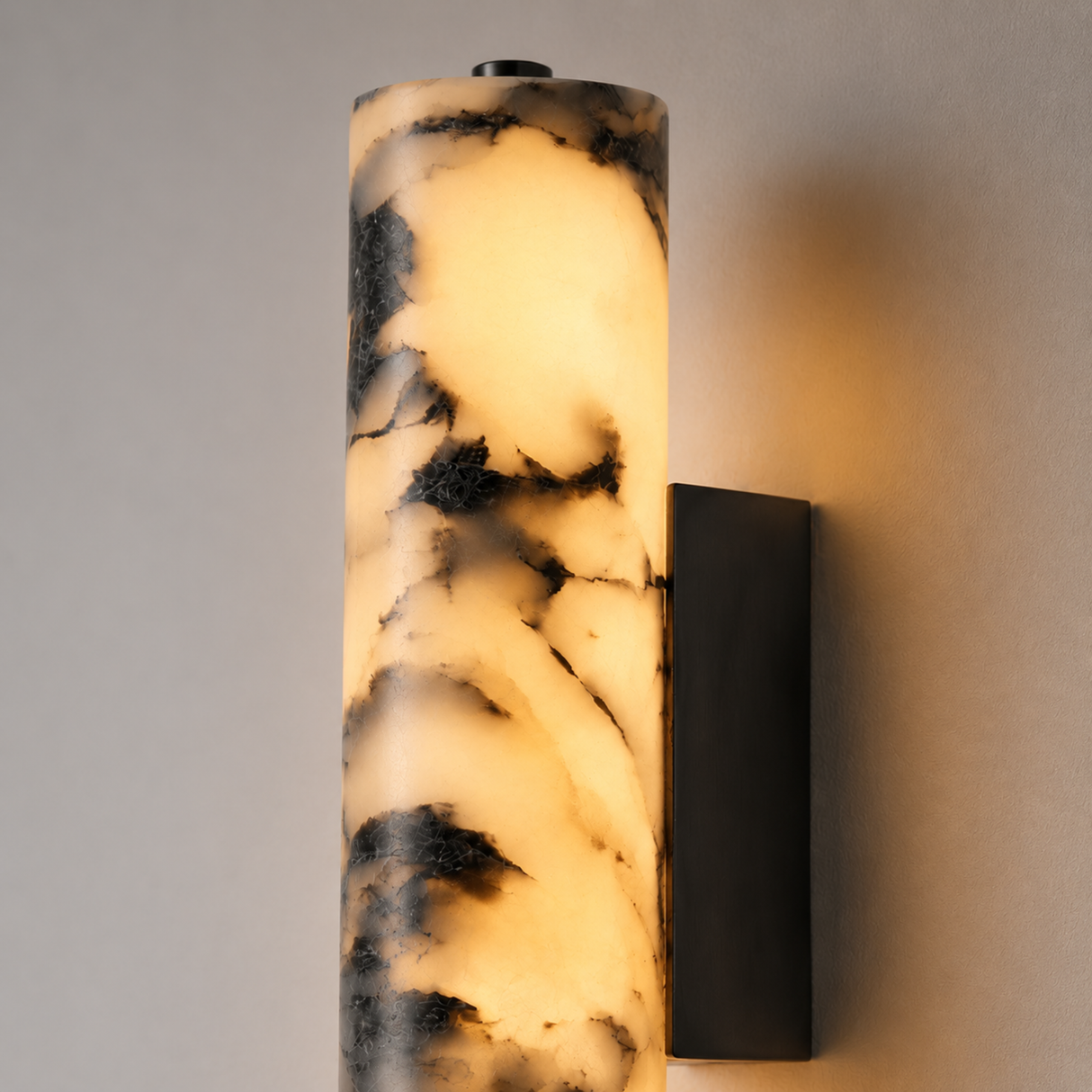 Marble-patterned cylindrical wall sconce on a neutral background