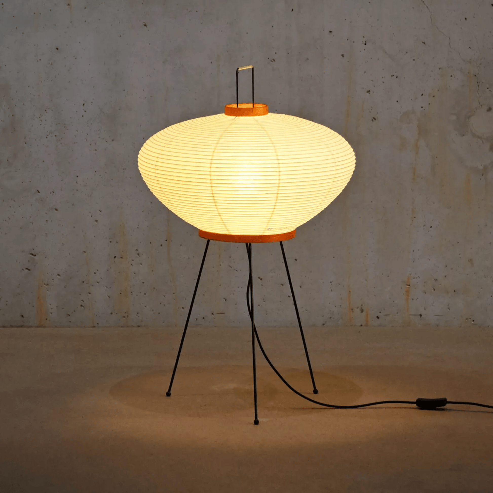 Vintage-style table lamp with a paper shade on a textured wall background