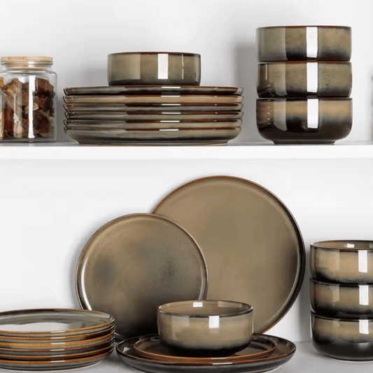 Set of brown ceramic dinnerware on a white background