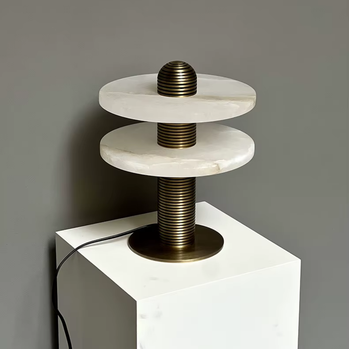Modern lamp with marble-like design on a gray background