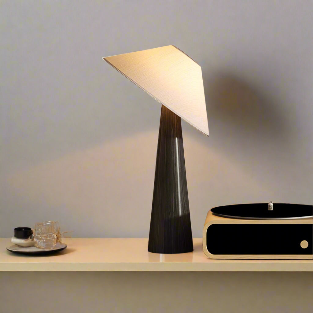 Modern table lamp on a bedside table with a cozy bedroom setting