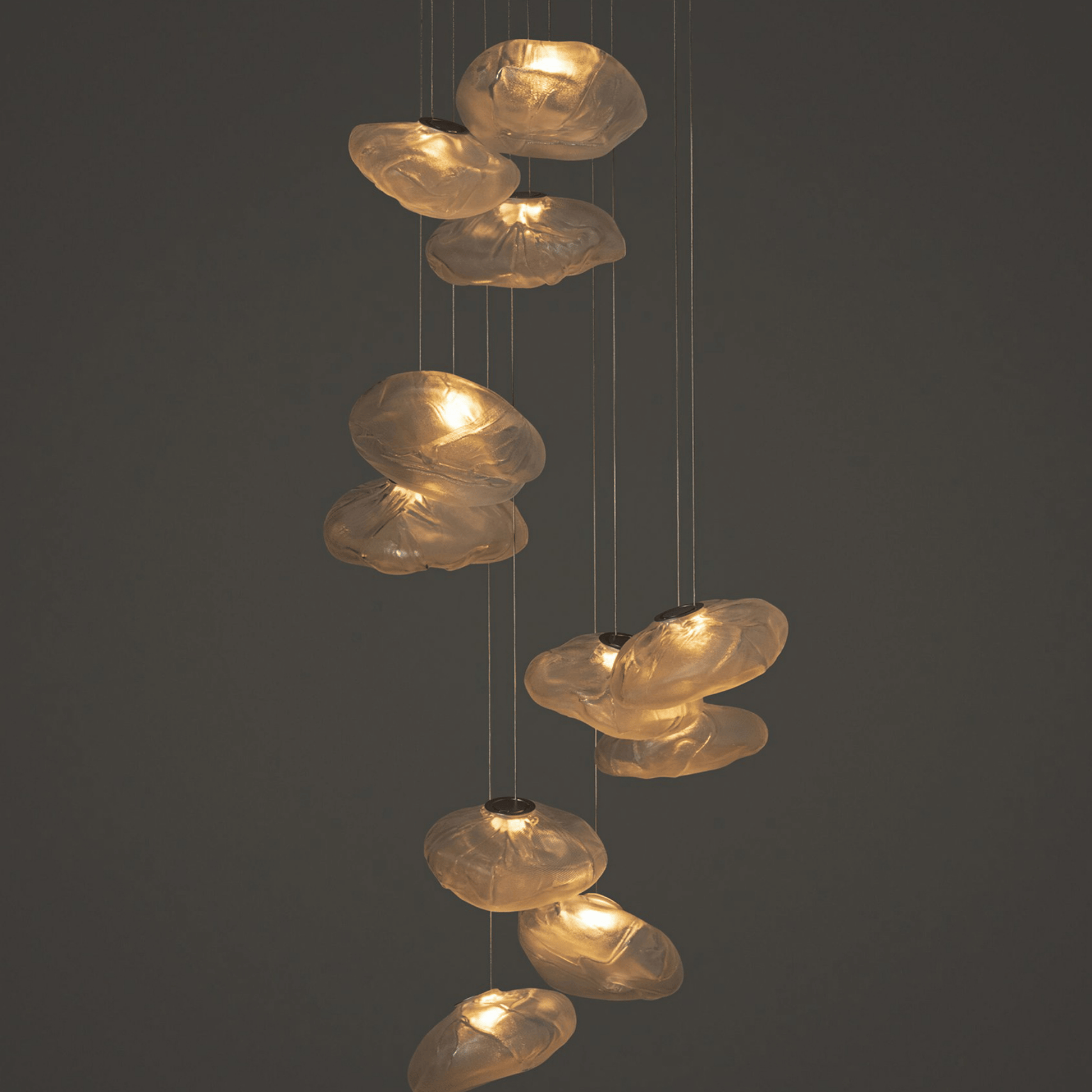 Decorative pendant light with glass shades on a dark background