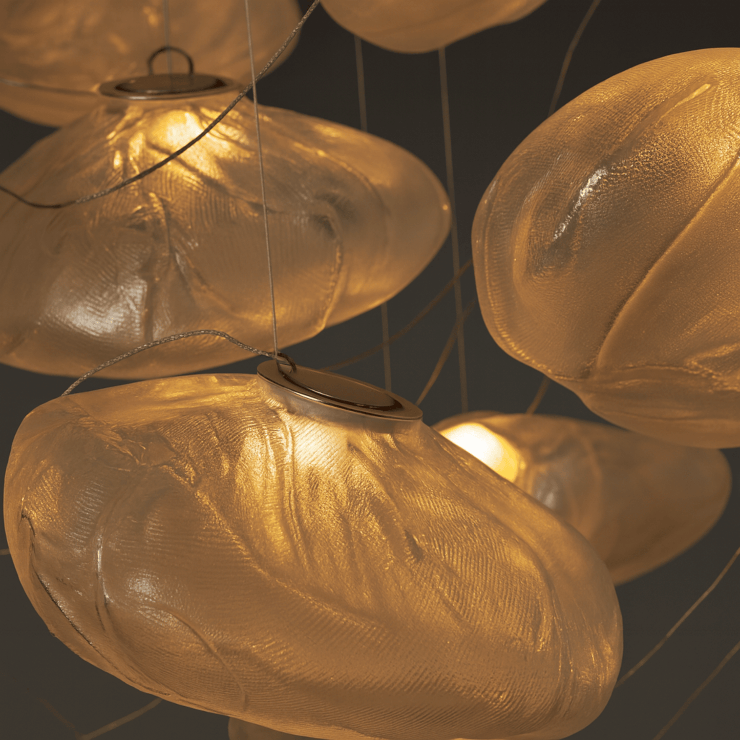 Close-up of a chandelier with glass shades on a dark background