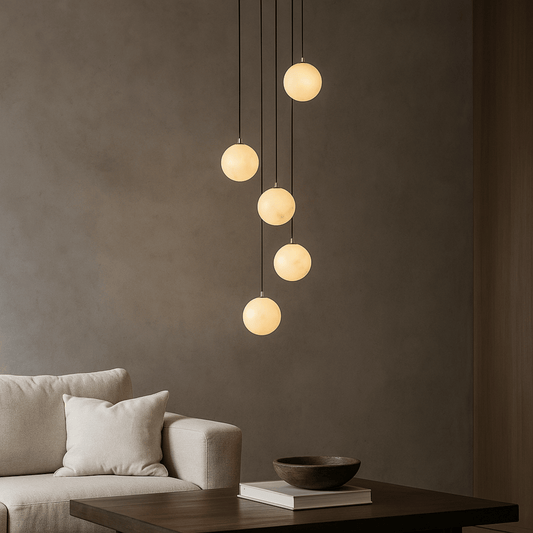 Modern pendant light fixture hanging above a sofa in a living room setting.