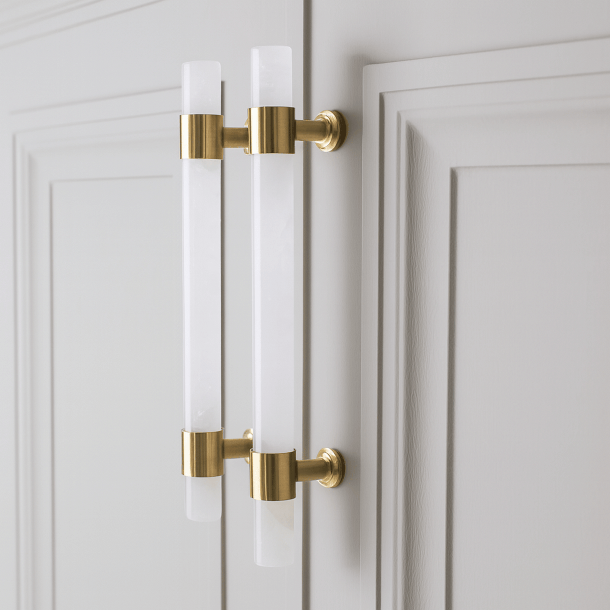 Gold cabinet handles on a white door