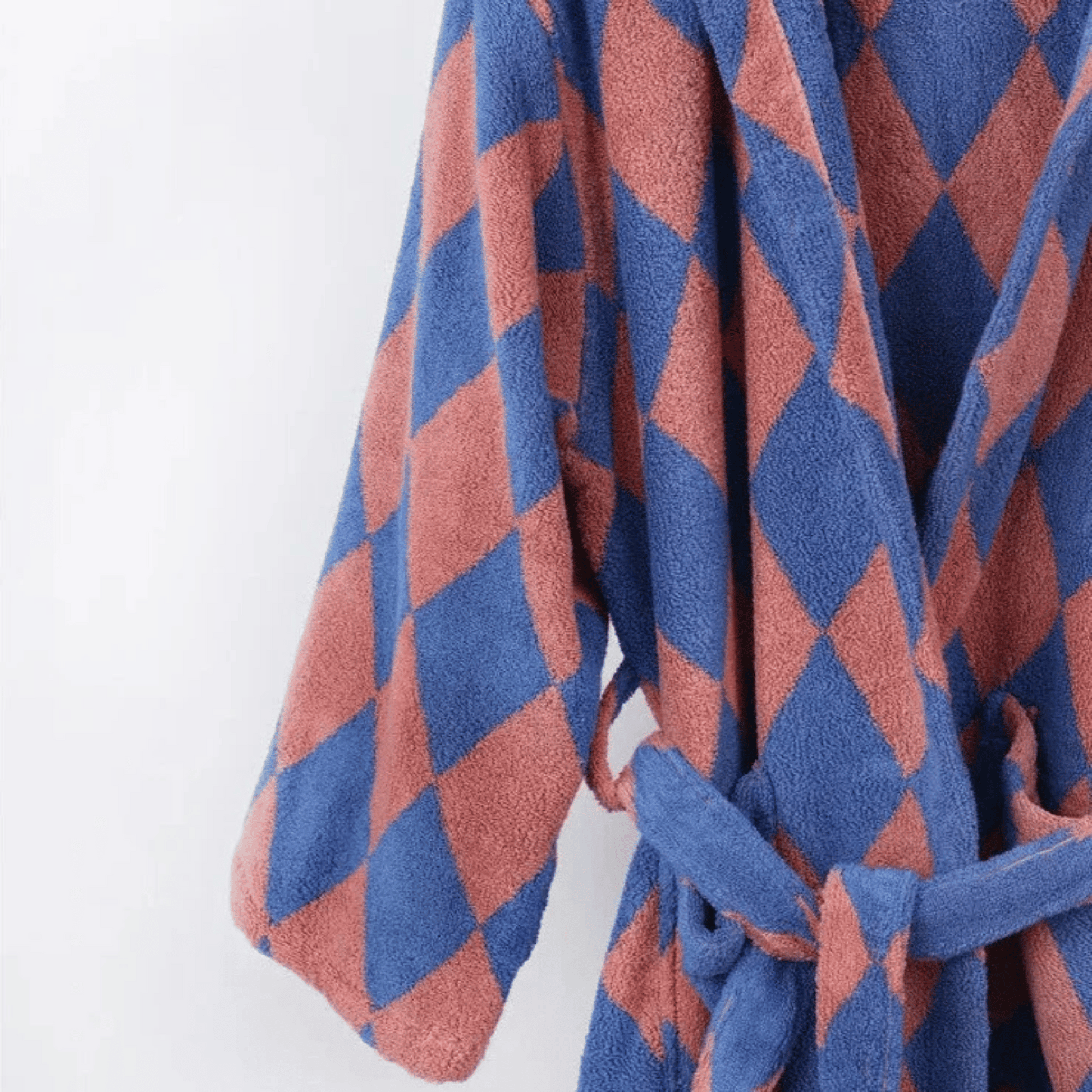 Blue and red diamond patterned robe on a white background