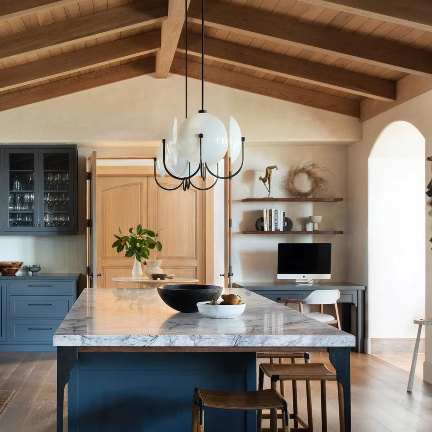 Modern kitchen with marble island and wooden beams