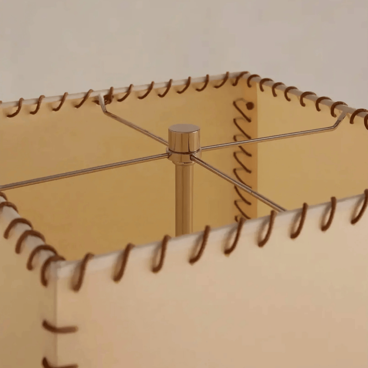 Close-up of a beige leather-bound notebook with stitching details.