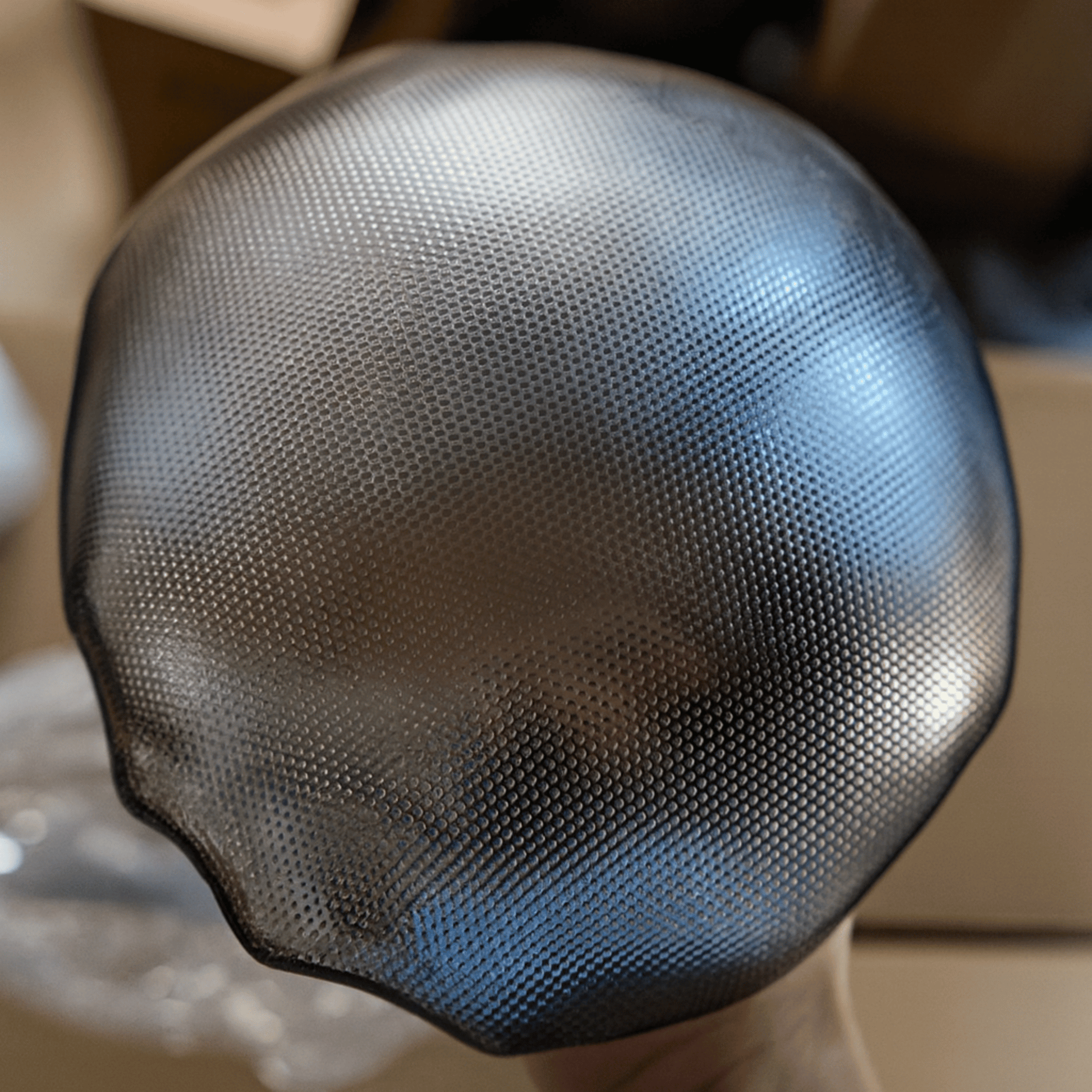 Close-up of a textured black object with a blurred background