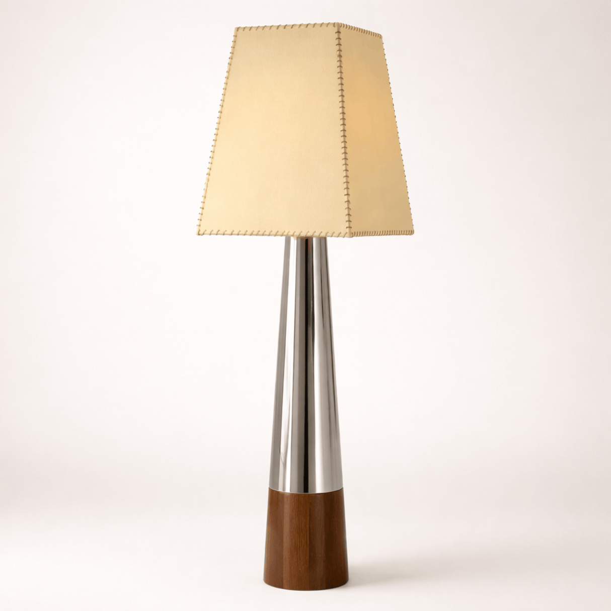 Table lamp with a wooden base, silver middle section, and beige fabric shade on a white background