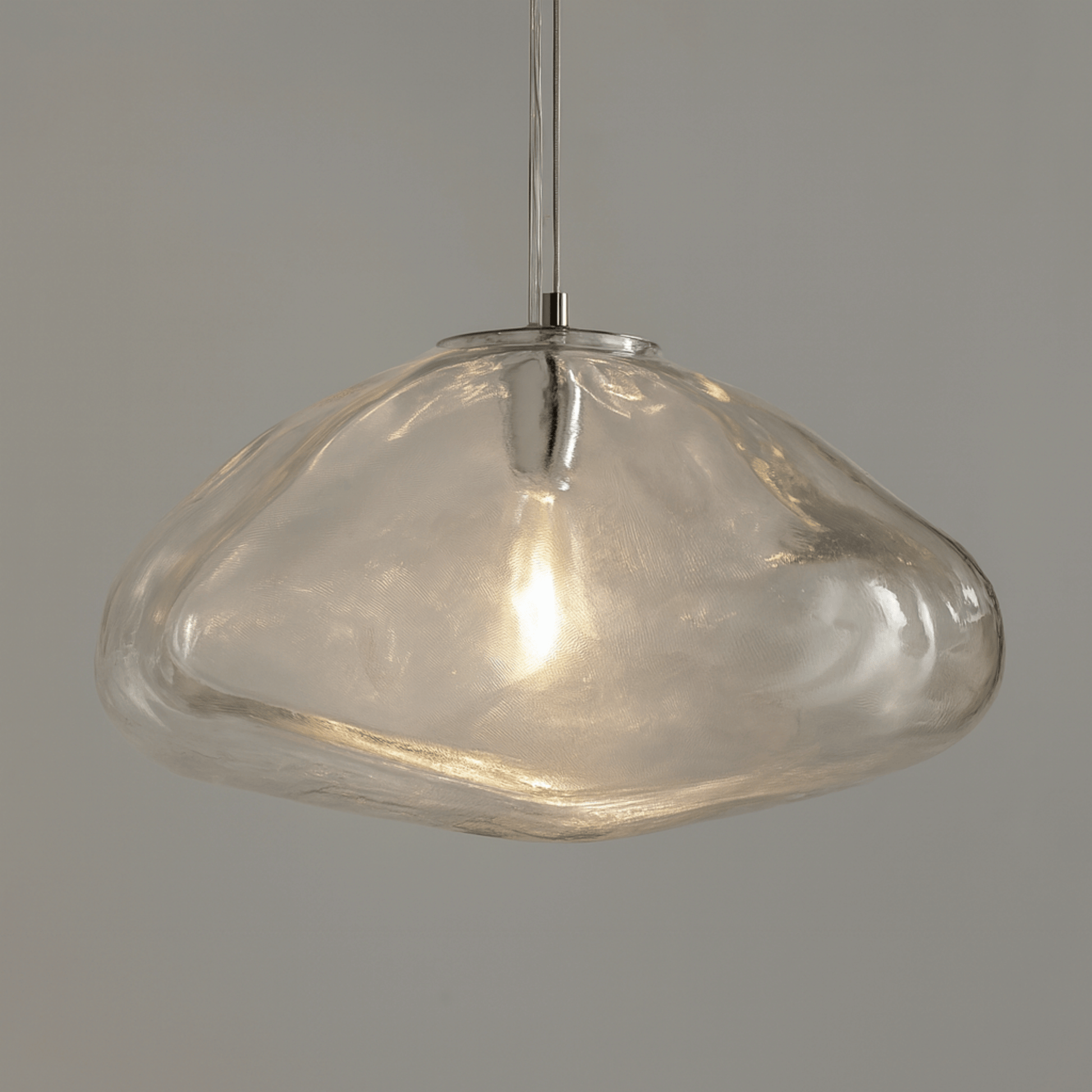 Clear glass pendant light on a gray background