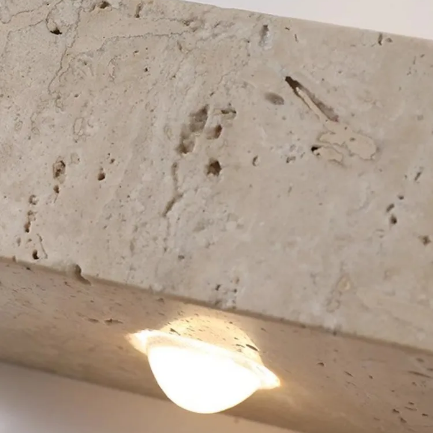 Light bulb on a textured stone surface