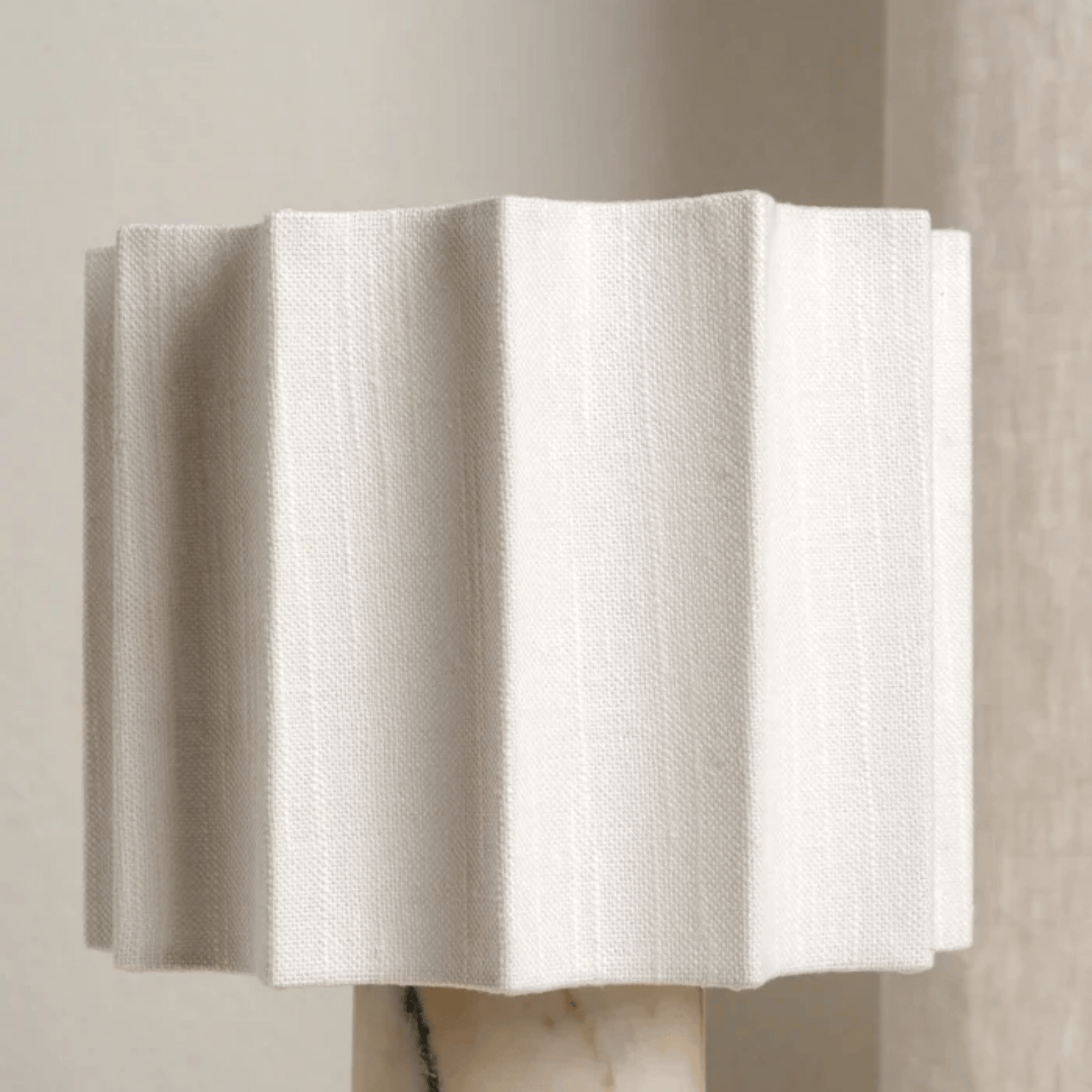 White textured wall art piece on a neutral background