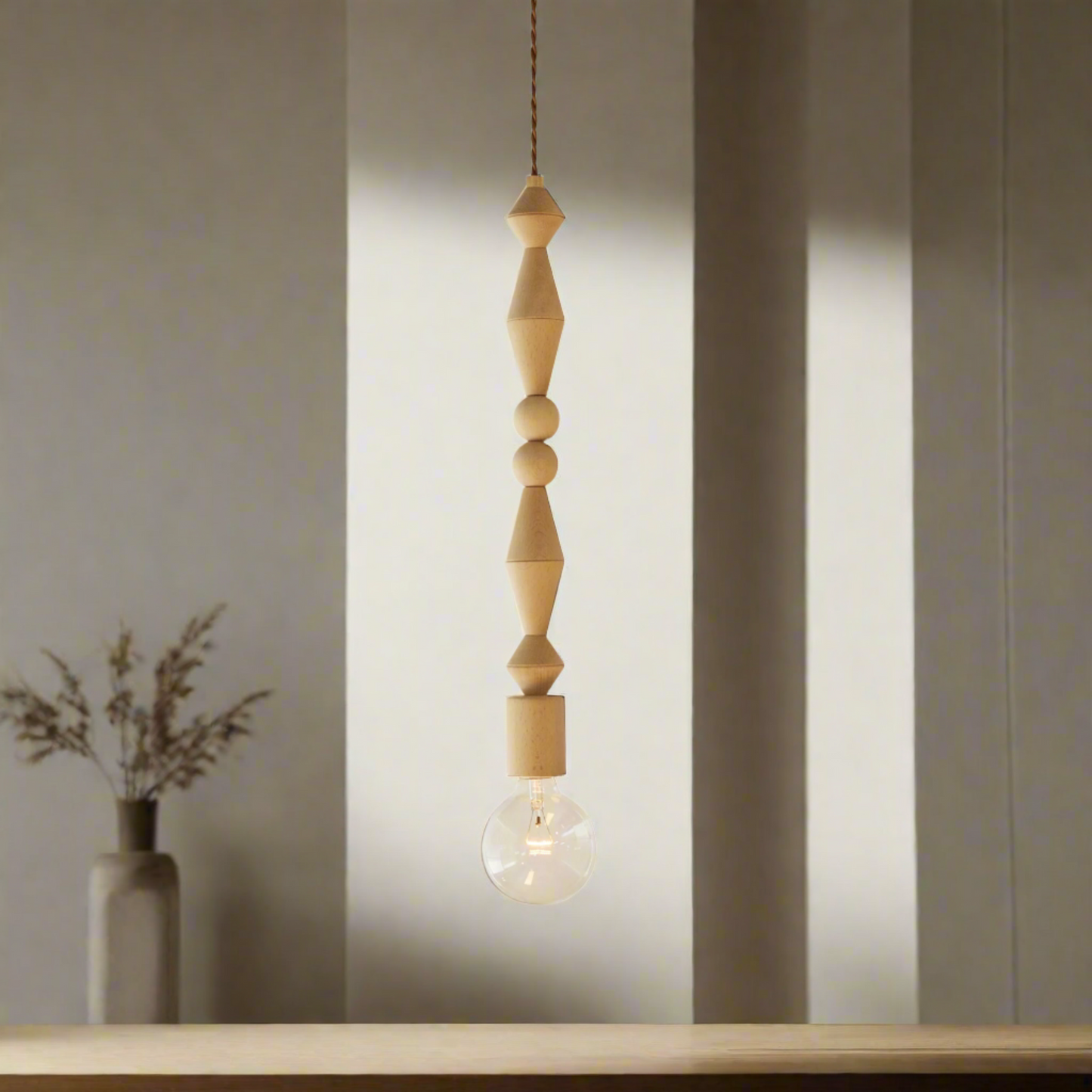 Pendant light with wooden beads and a light bulb on a white background