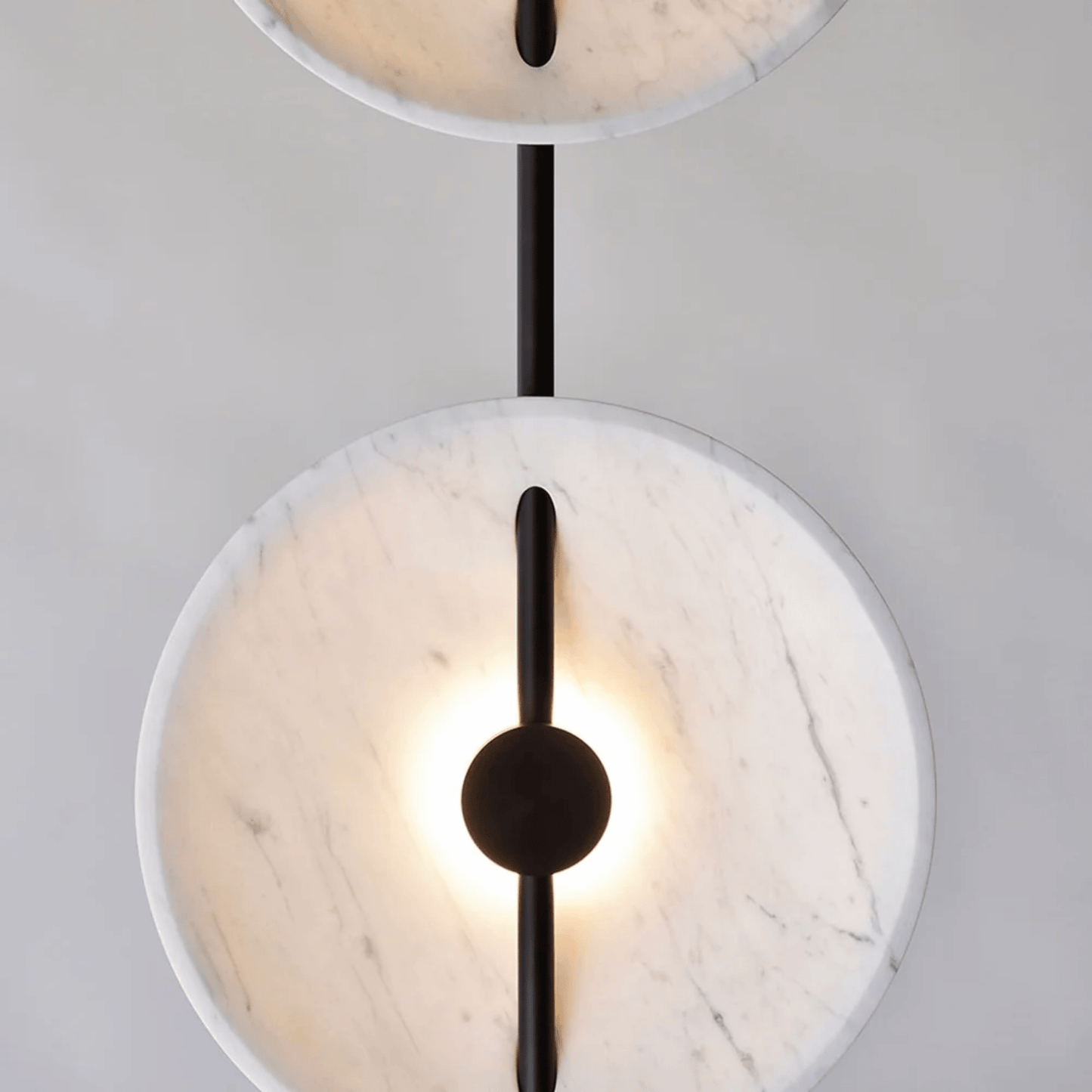 Modern ceiling light fixture with marble-like finish and black accents on a neutral background