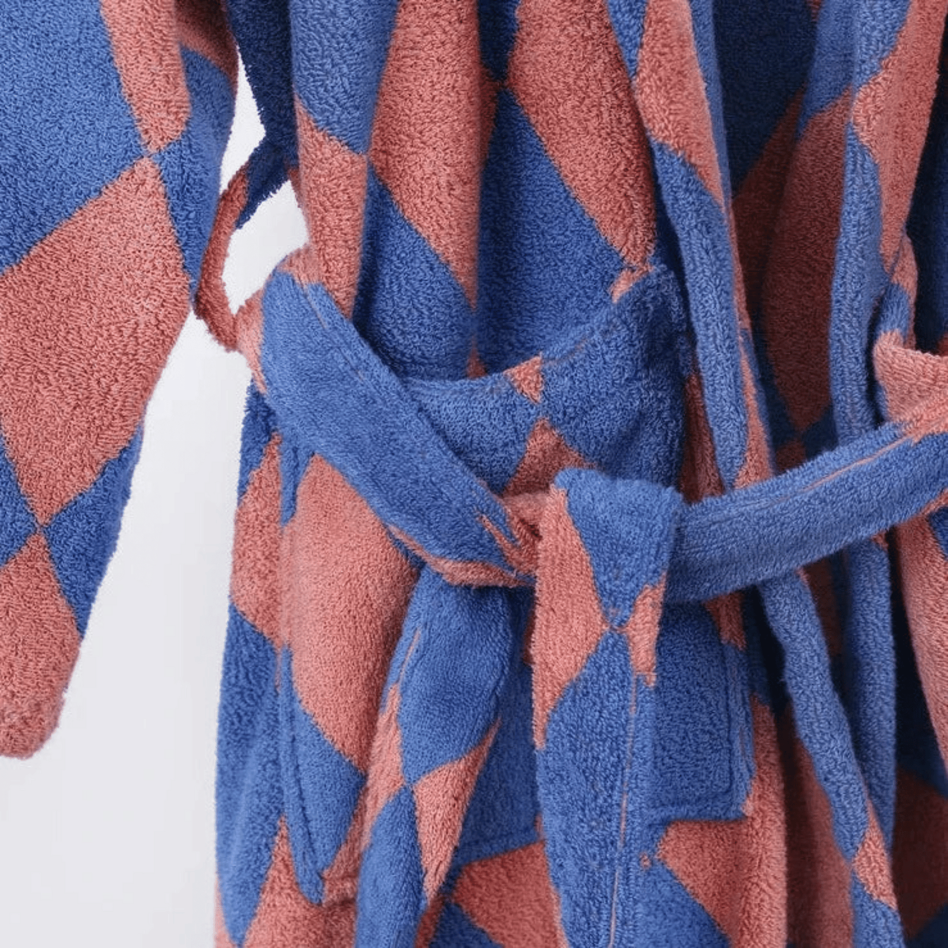 Close-up of a blue and pink patterned robe with a tie.