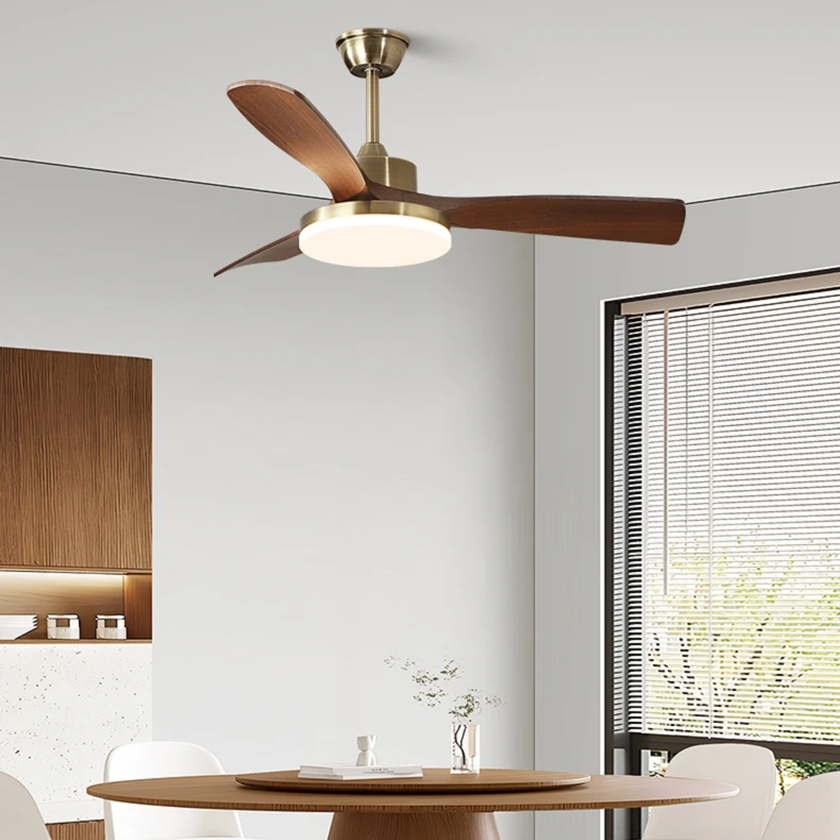 Ceiling fan with light fixture in a modern room with a table and lamp.