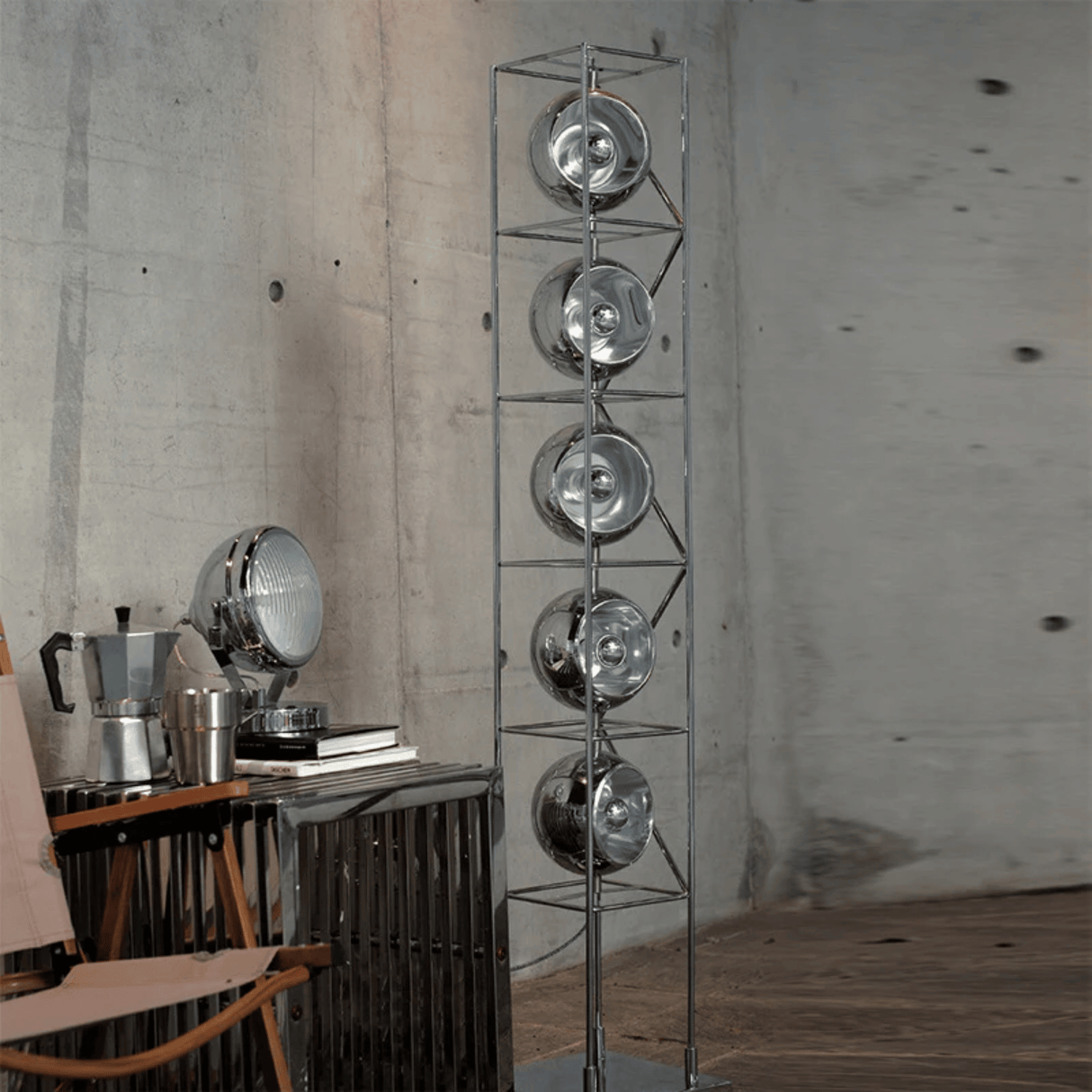 Metallic floor lamp with circular design elements in a room setting.